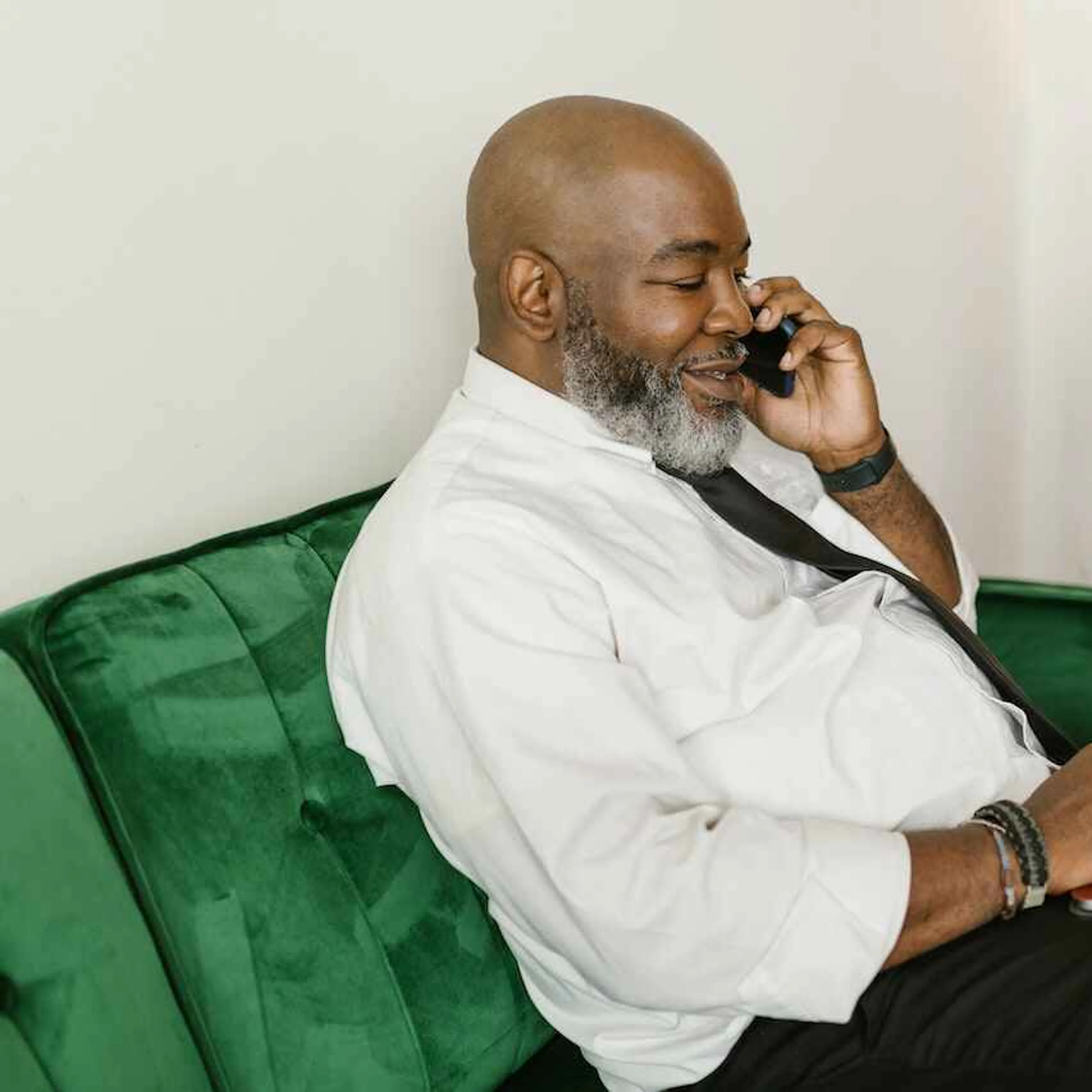 Older man on a sofa with a laptop