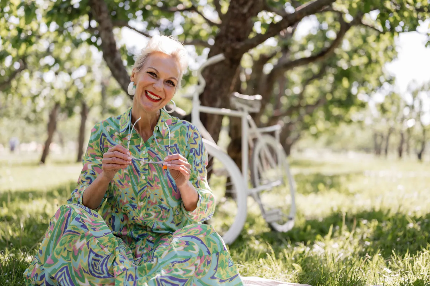 Older woman in green dress in field