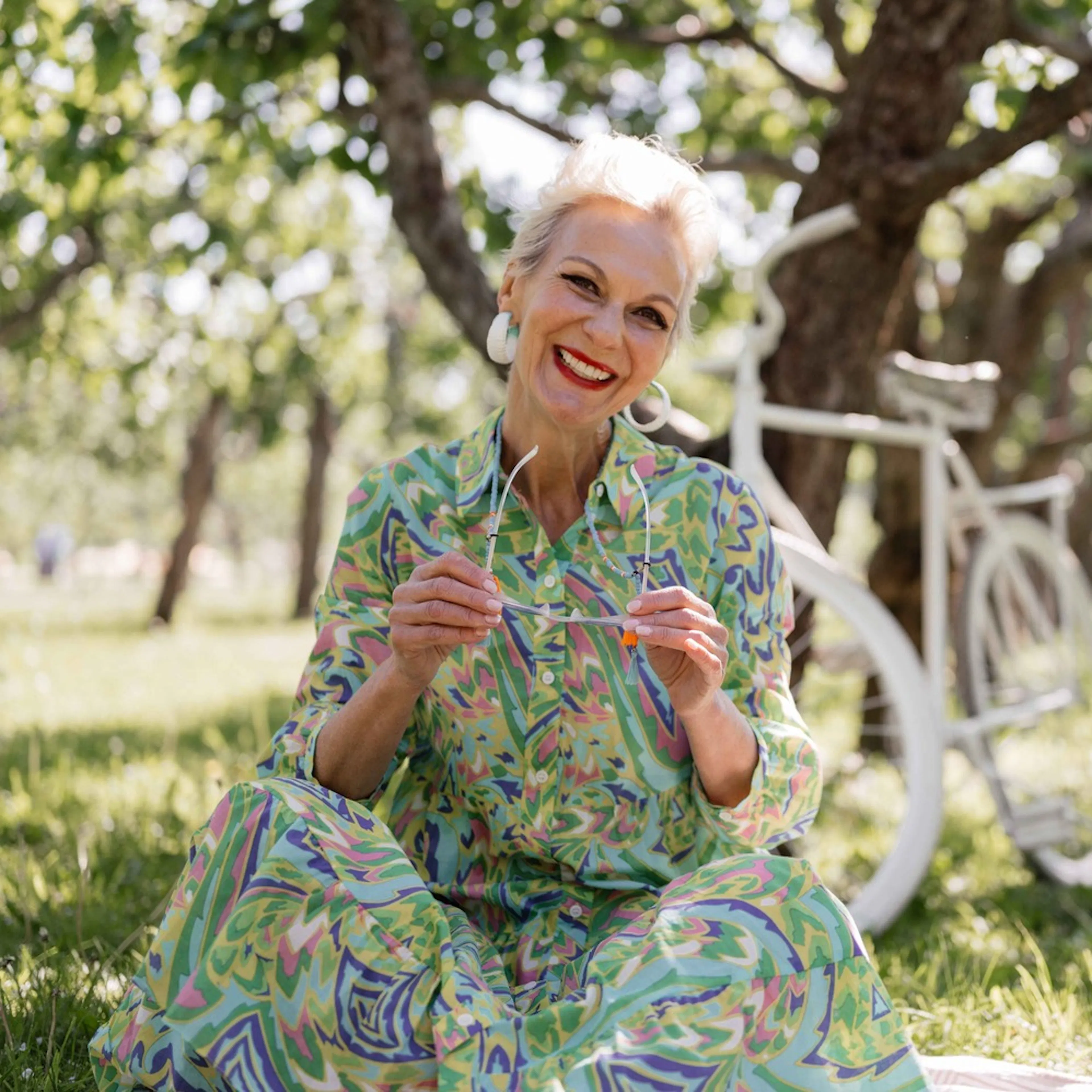 Older woman in green dress in field 