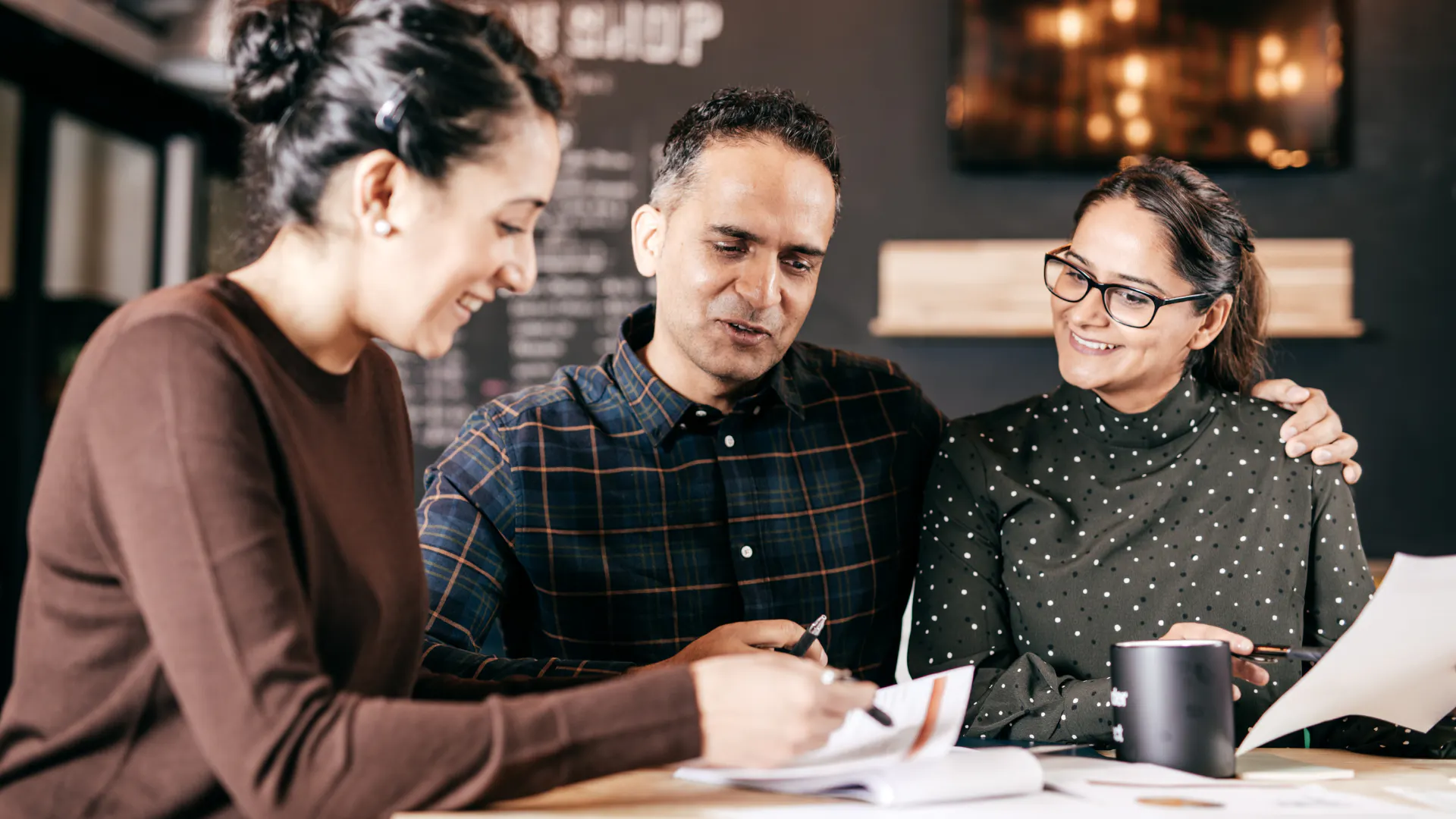 group of three having a meeting