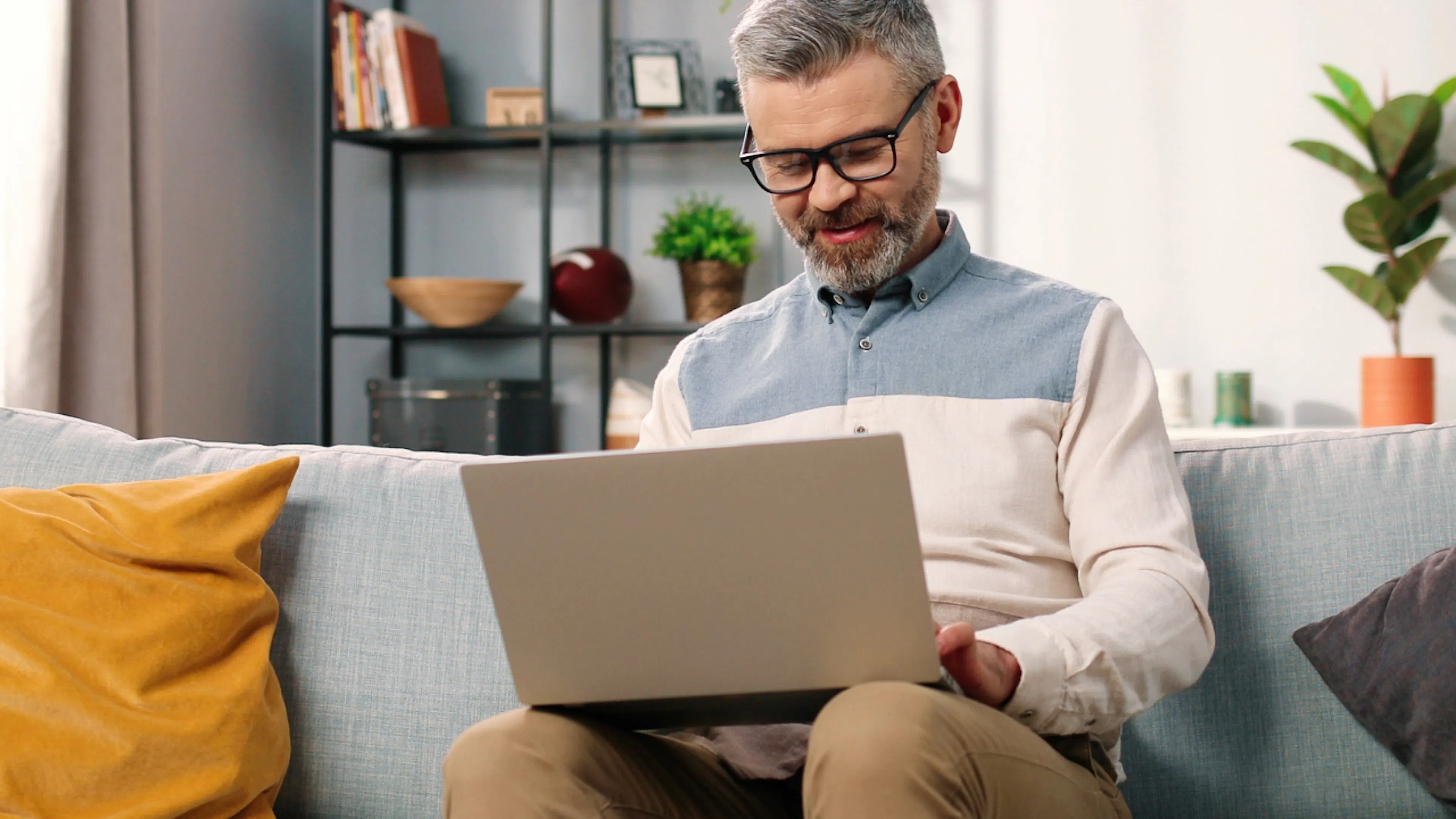 Man on laptop on sofa