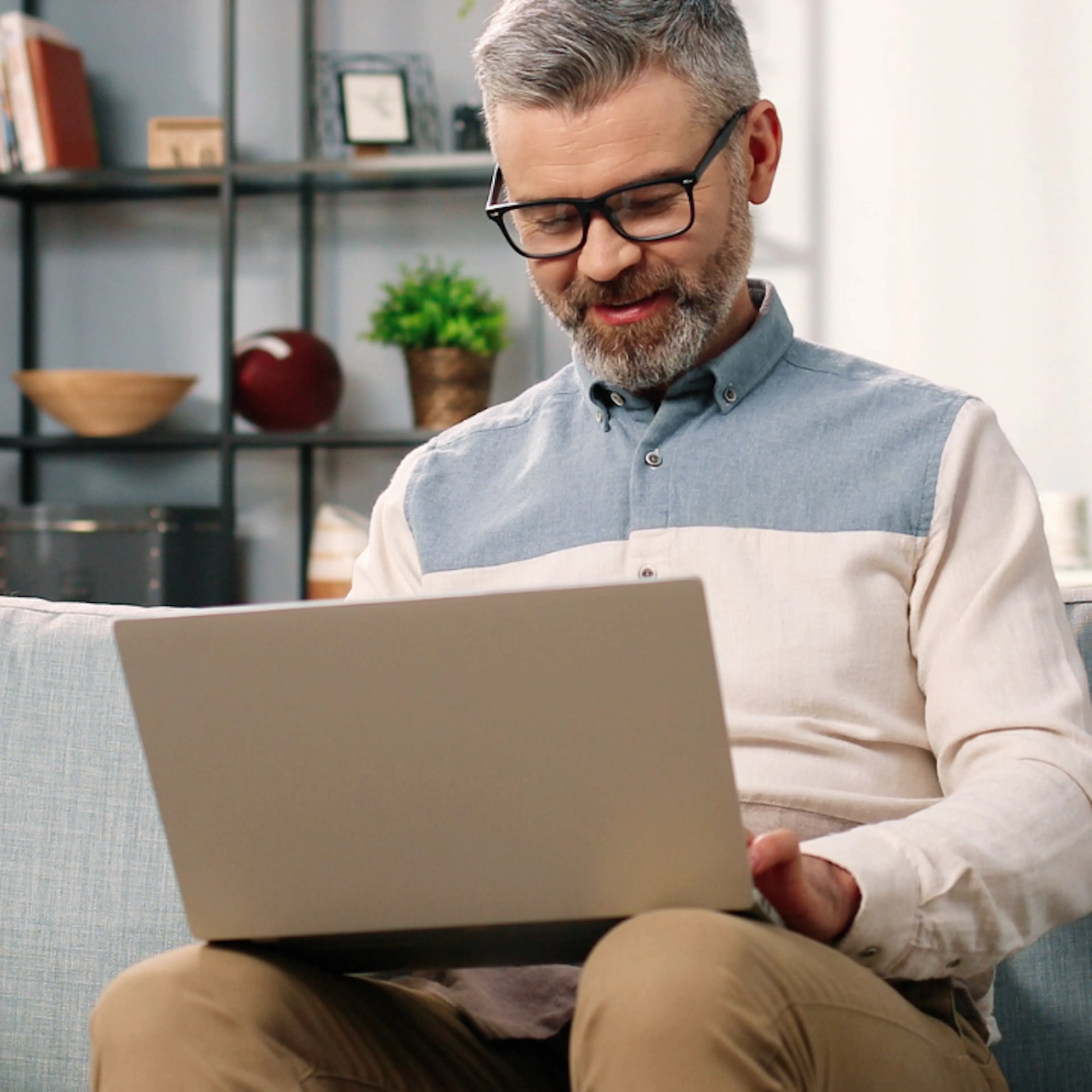 Man on laptop on sofa