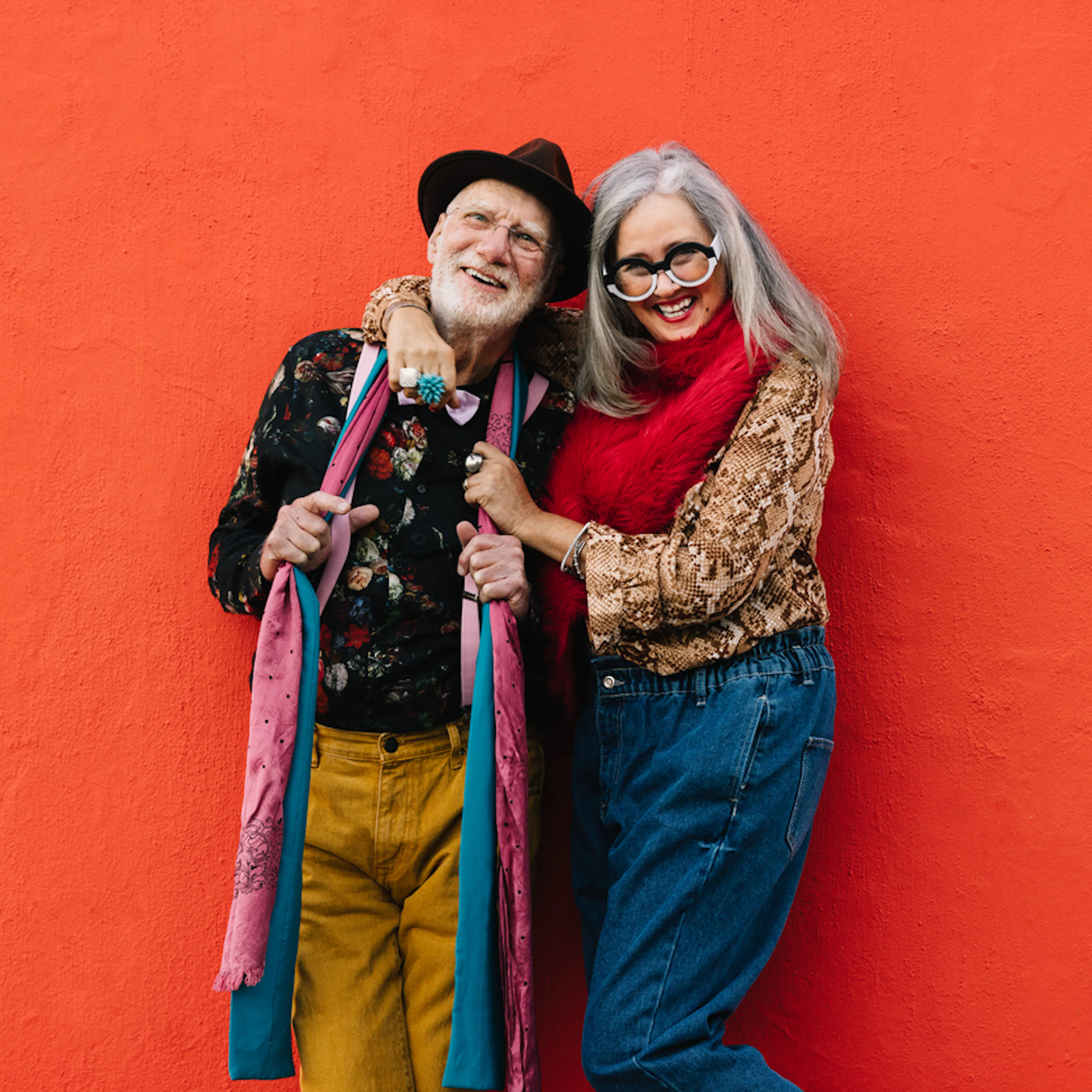 mature man with hat and woman in glasses smiling