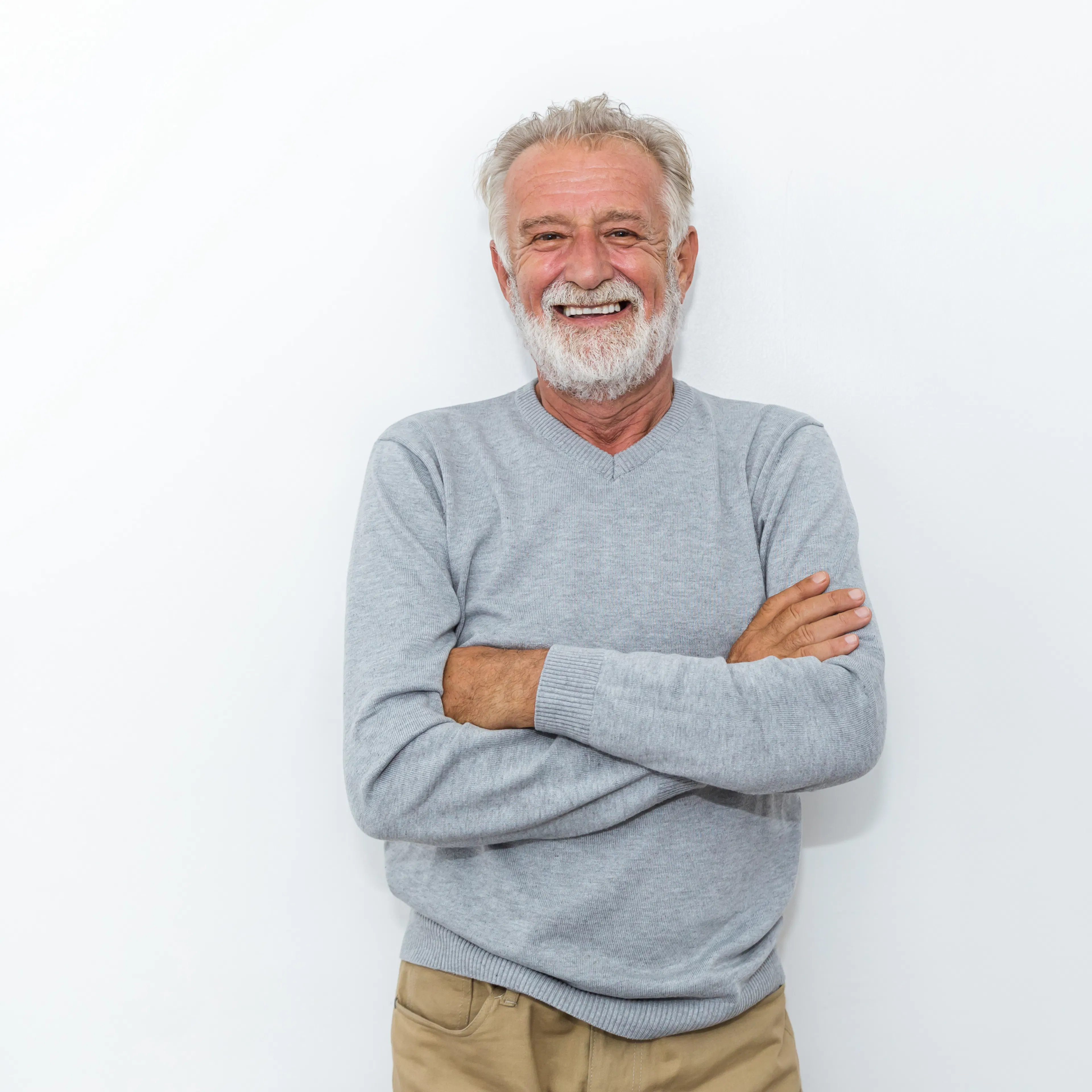 smiling mature man looking at camera with arms crossed