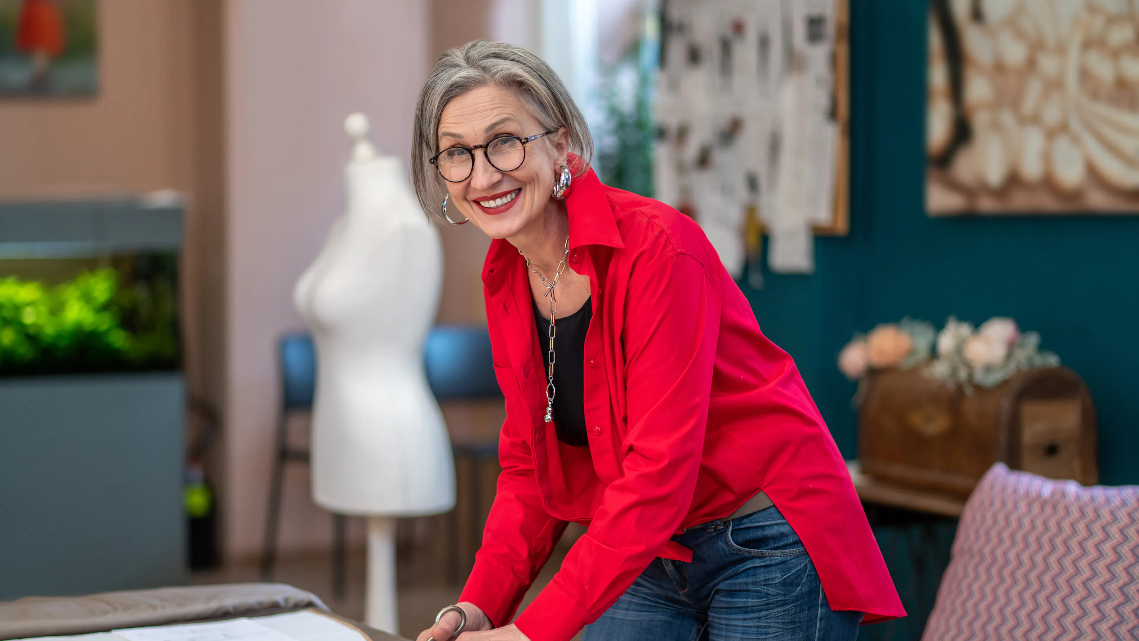 Energetic older woman in red shirt at table