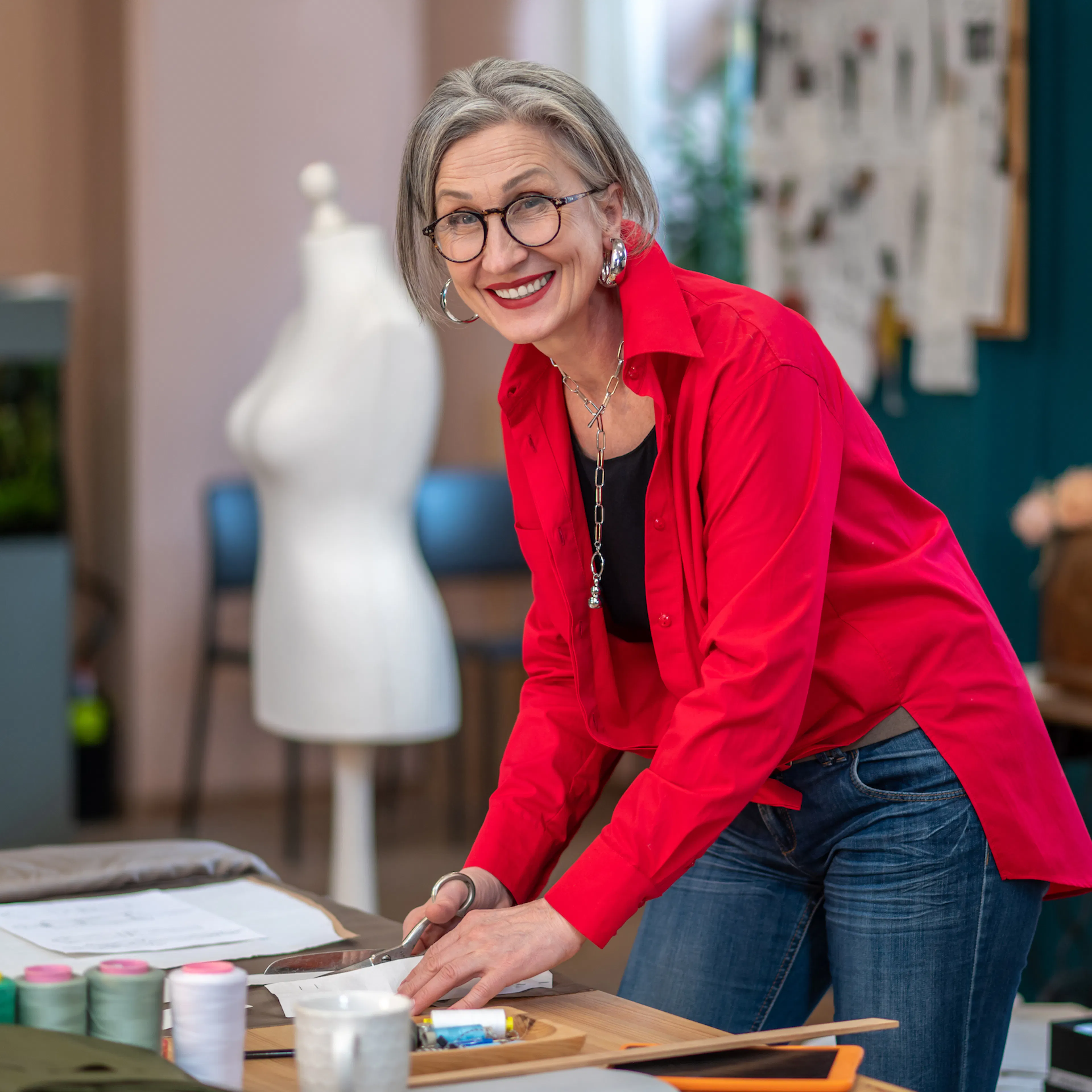 Energetic older woman in red shirt at table