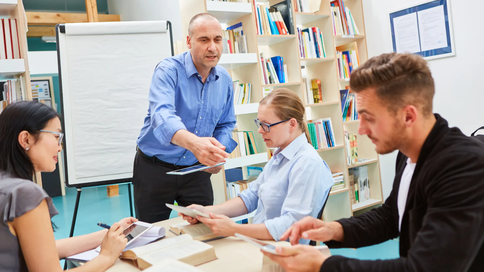 male adult education teaching small group of adults