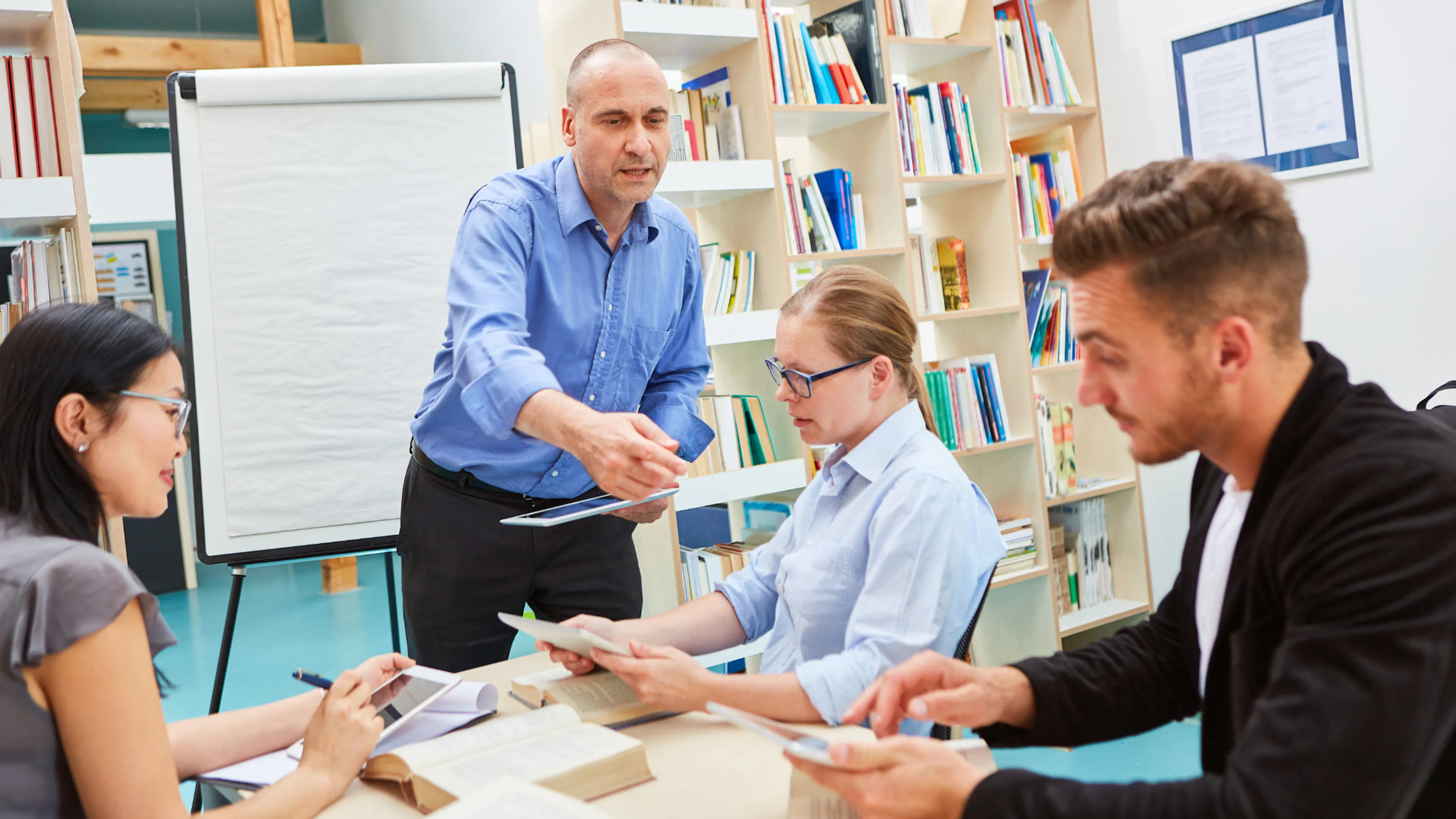 male adult education teaching small group of adults