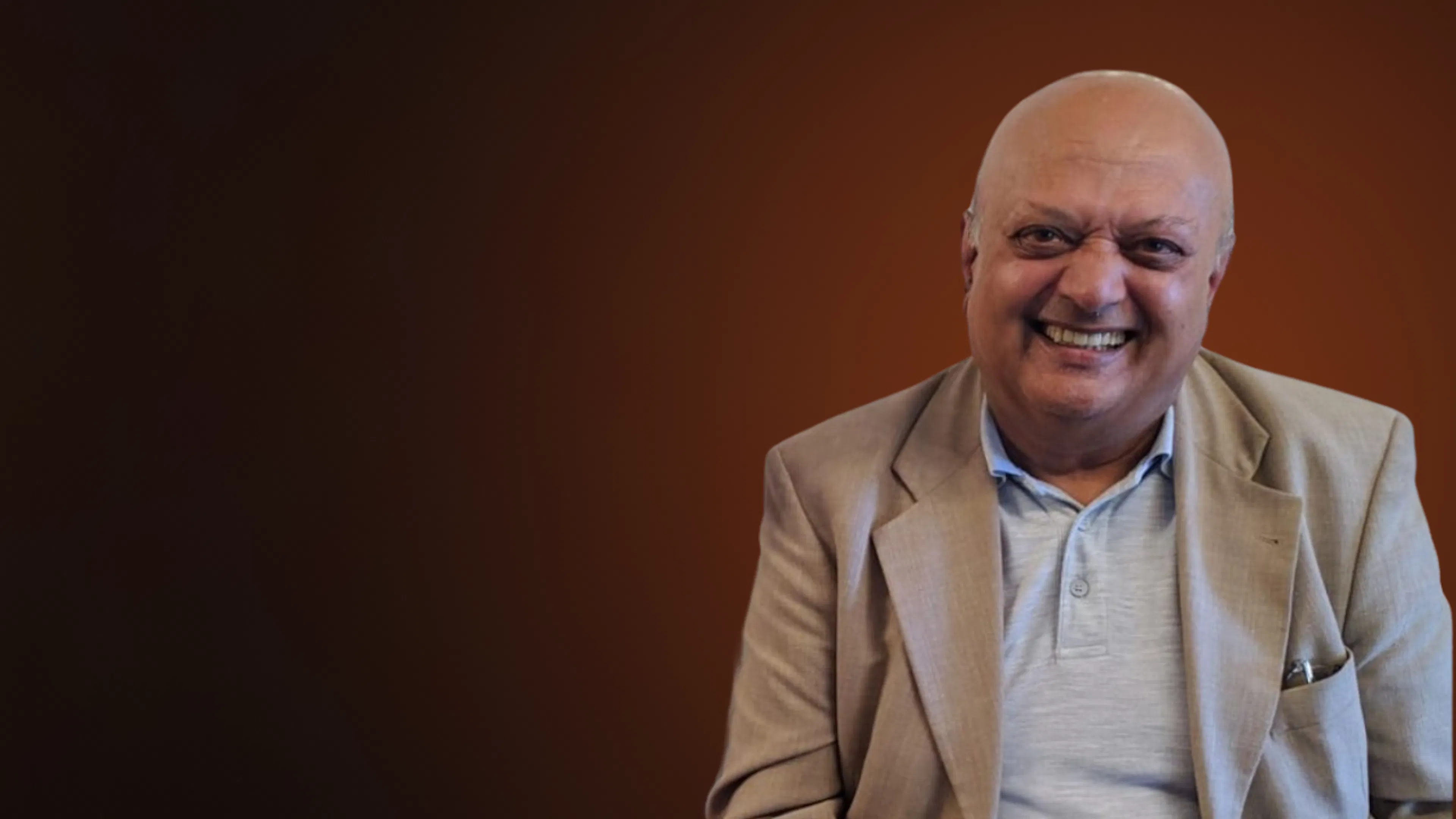 Des Desai Headshot, smiling at camera