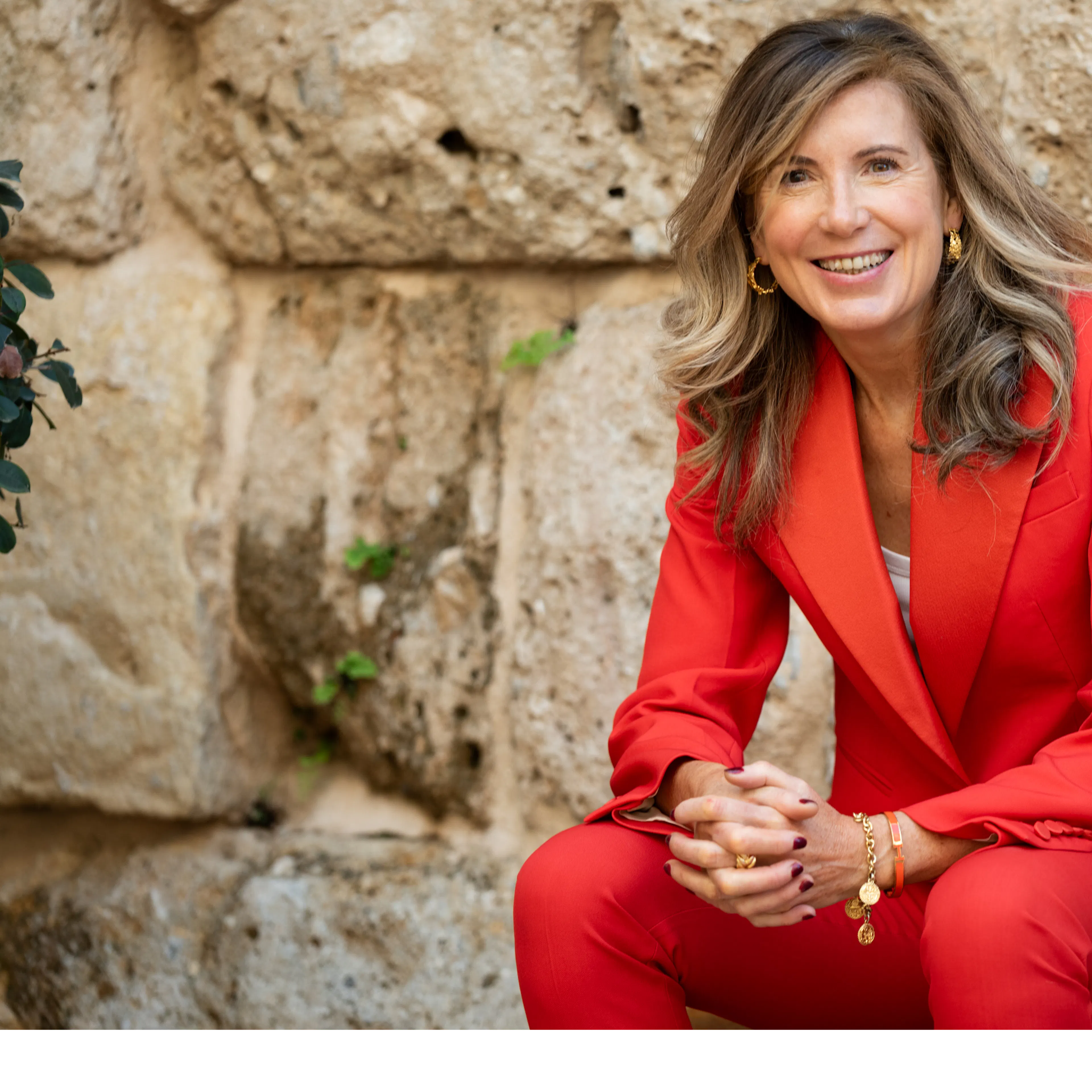 Karen Muldoon wearing red suit smiling at camera