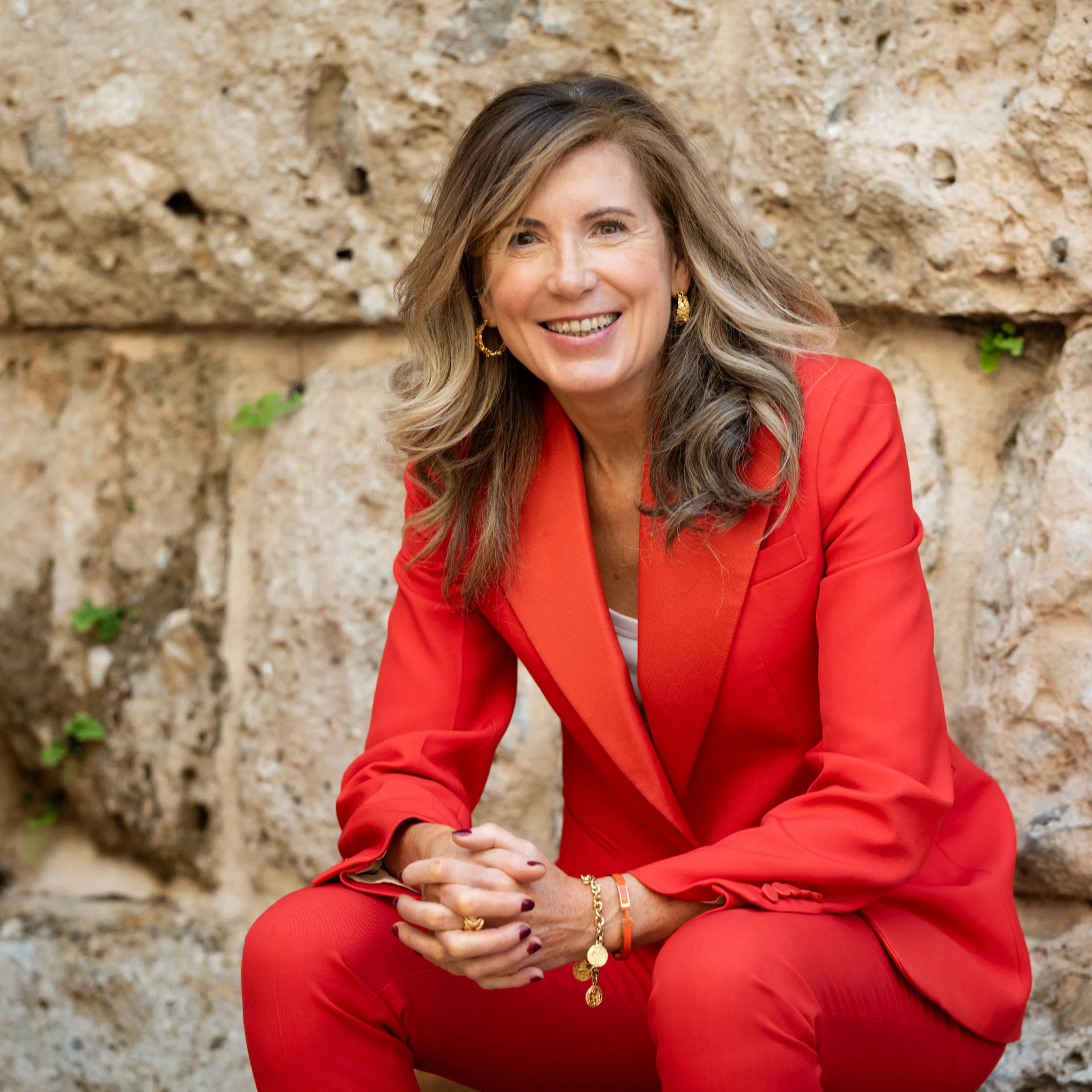 Karen Muldoon wearing red suit smiling at camera