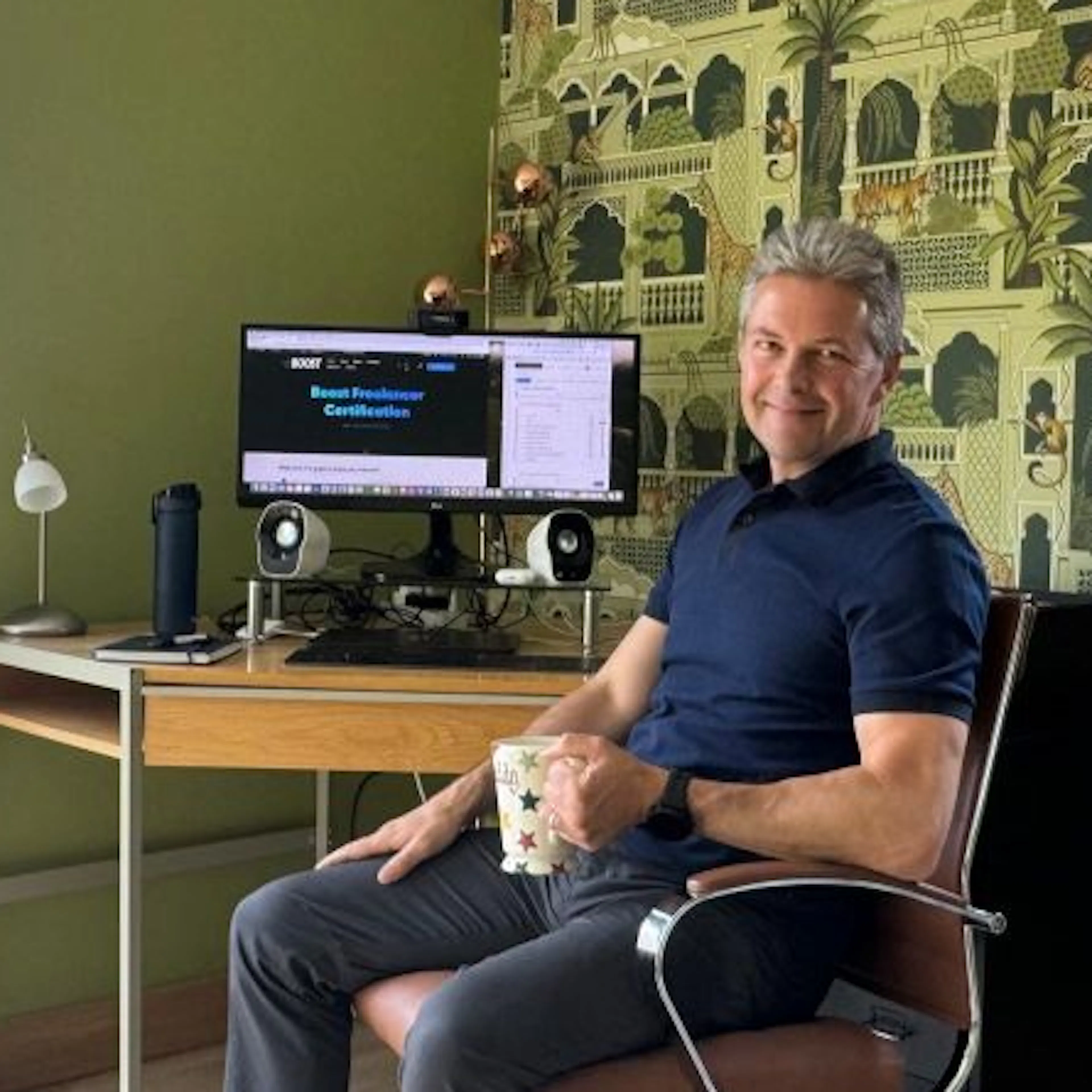 Adrian Whitcombe sitting at desk