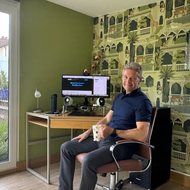 Adrian Whitcombe sitting at desk