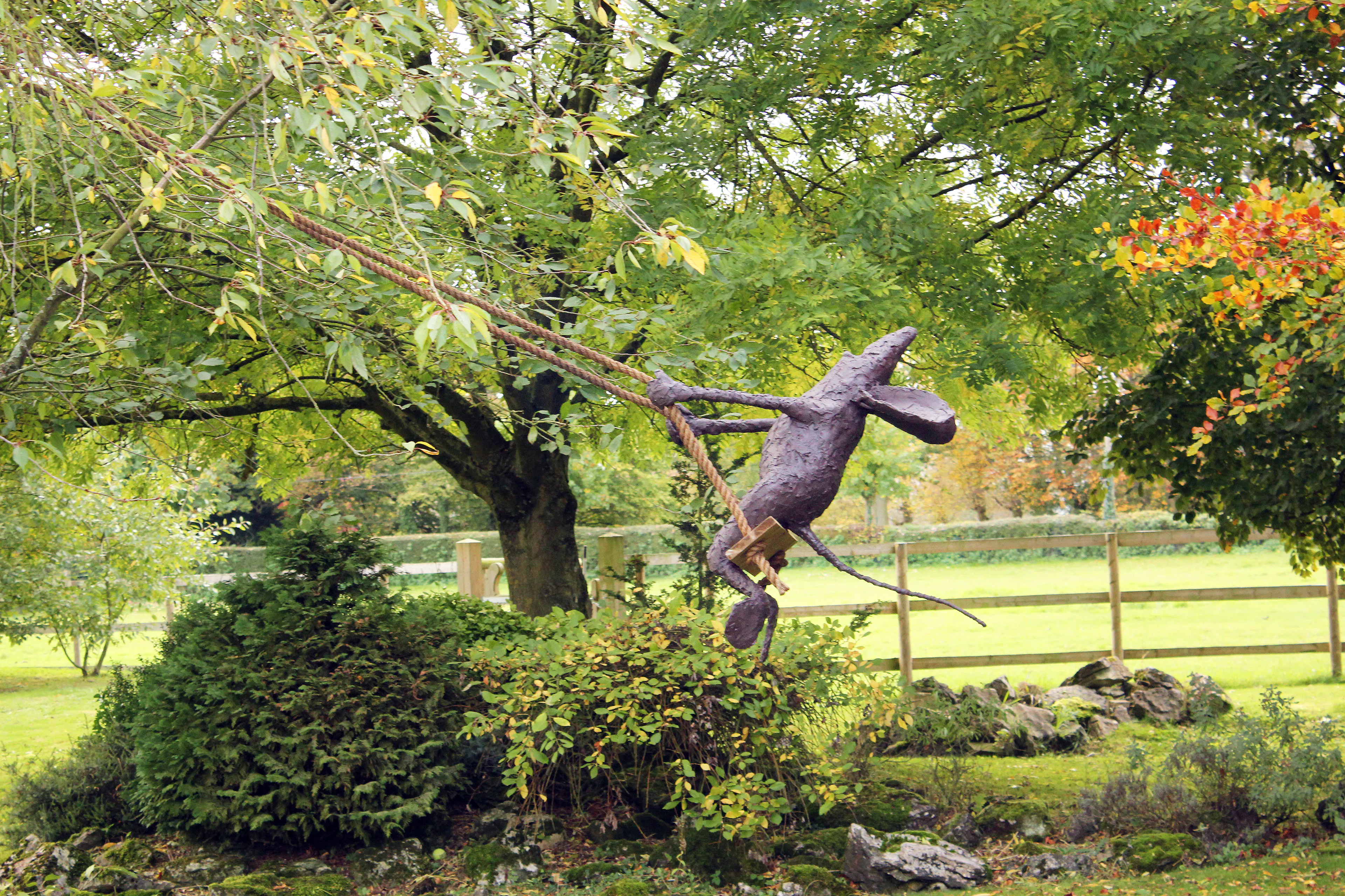 A sculpture of a mouse on a swing by Stephen Charlton.