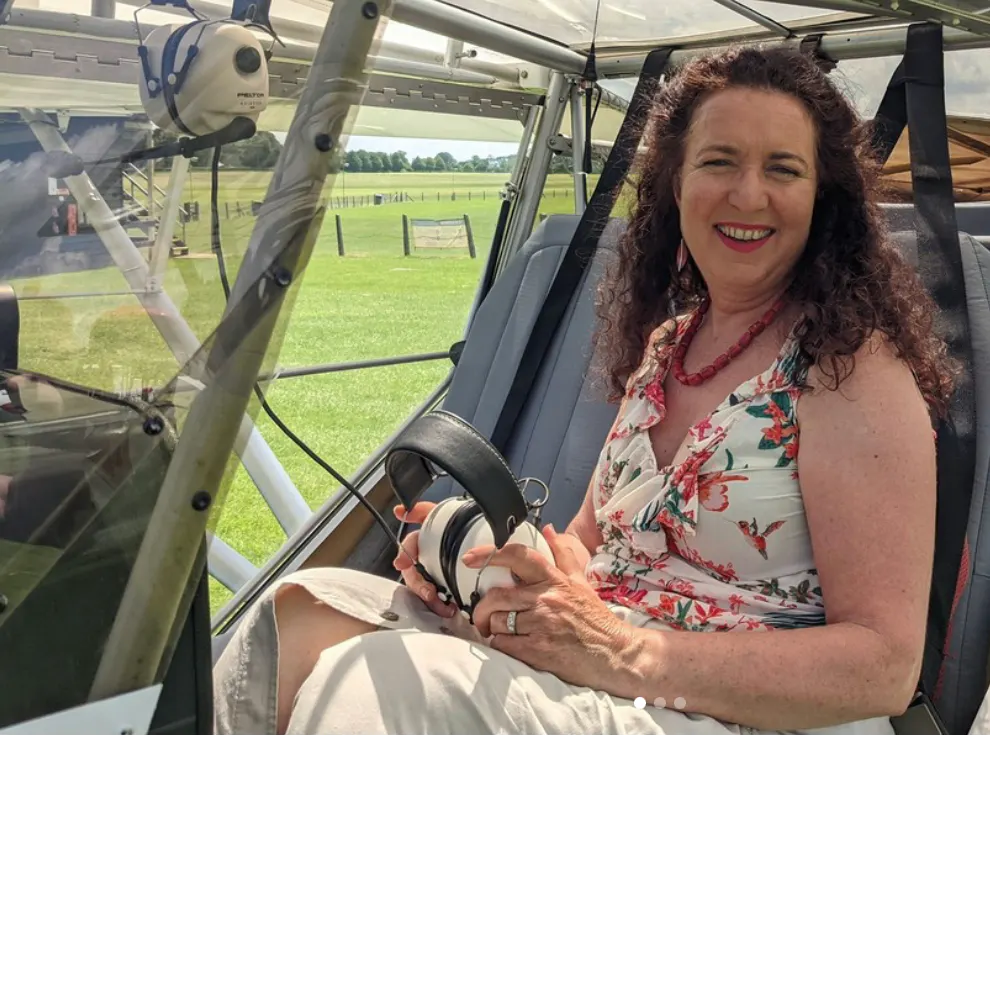 Nushi Elahi sat in plane holding looking at camera