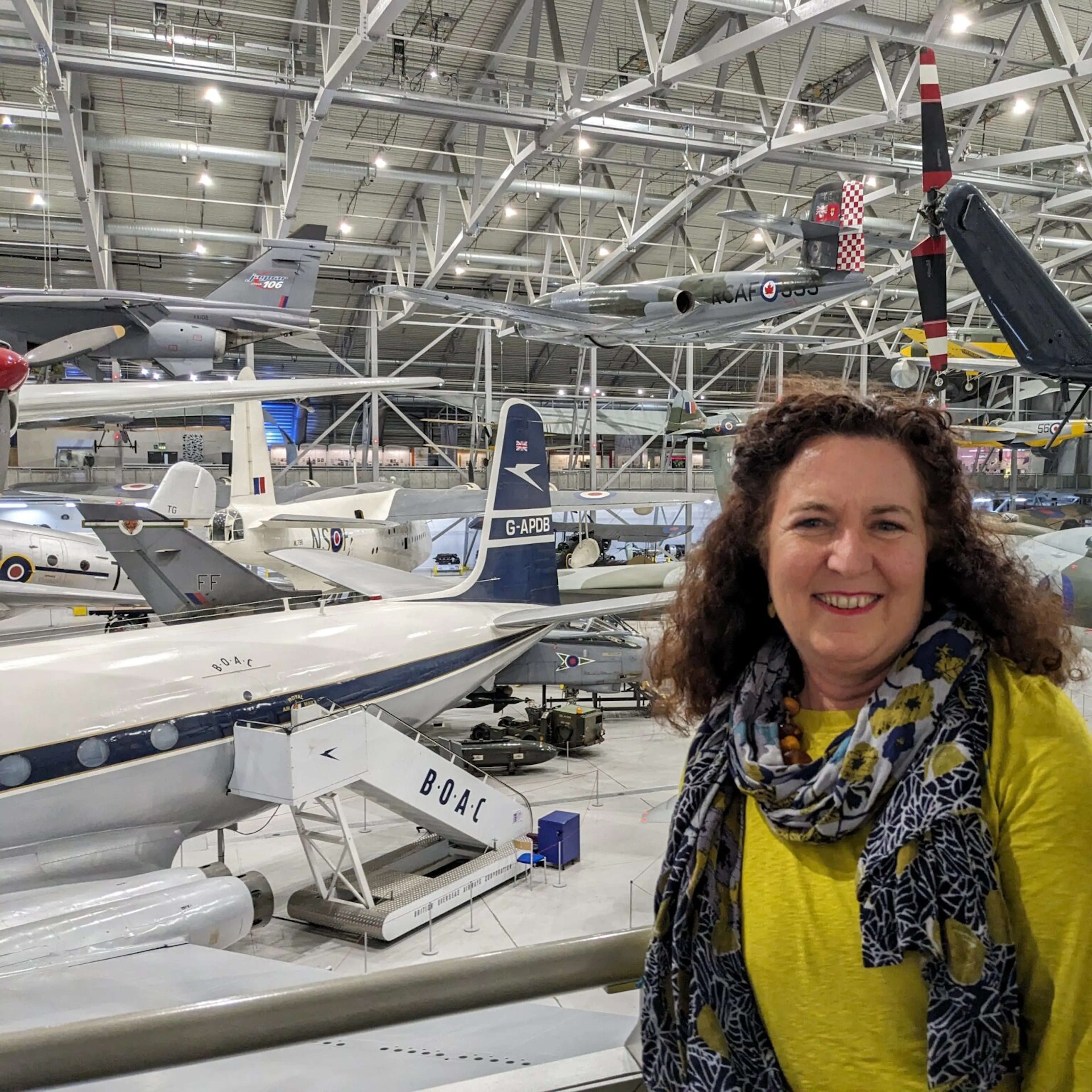 Nushin Elahi standing inside an airplane hanger