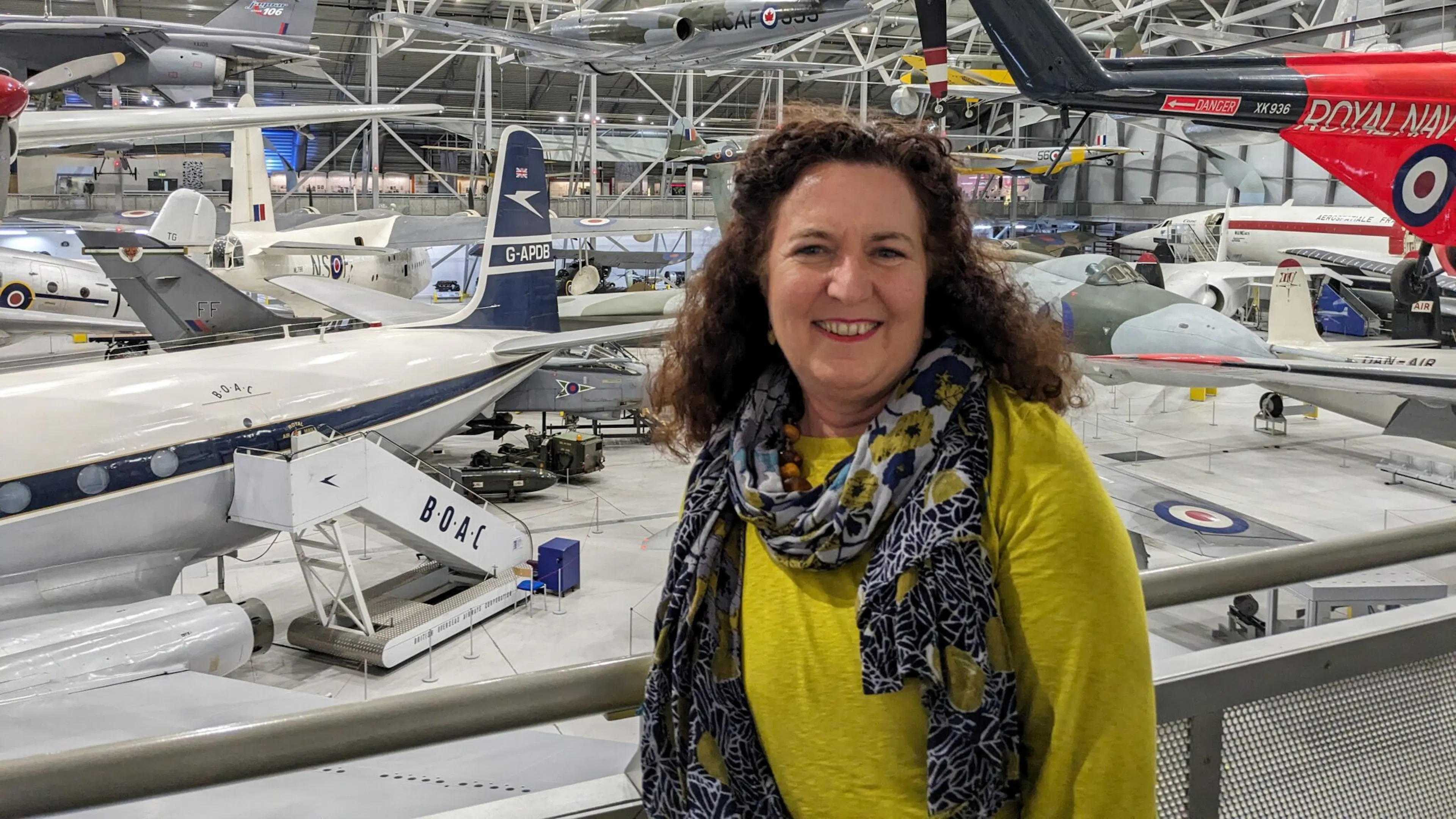 Nushin Elahi standing inside an airplane hanger