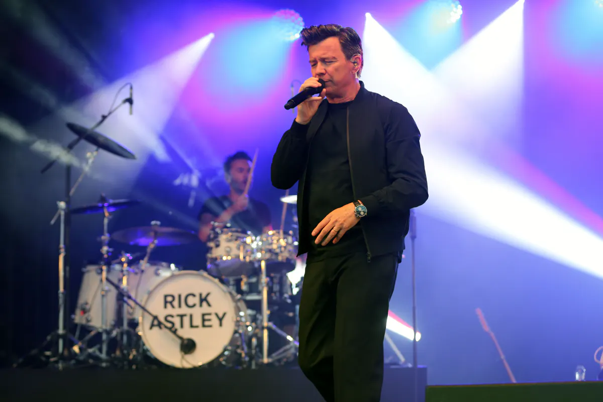 Rick Astley performs on stage.