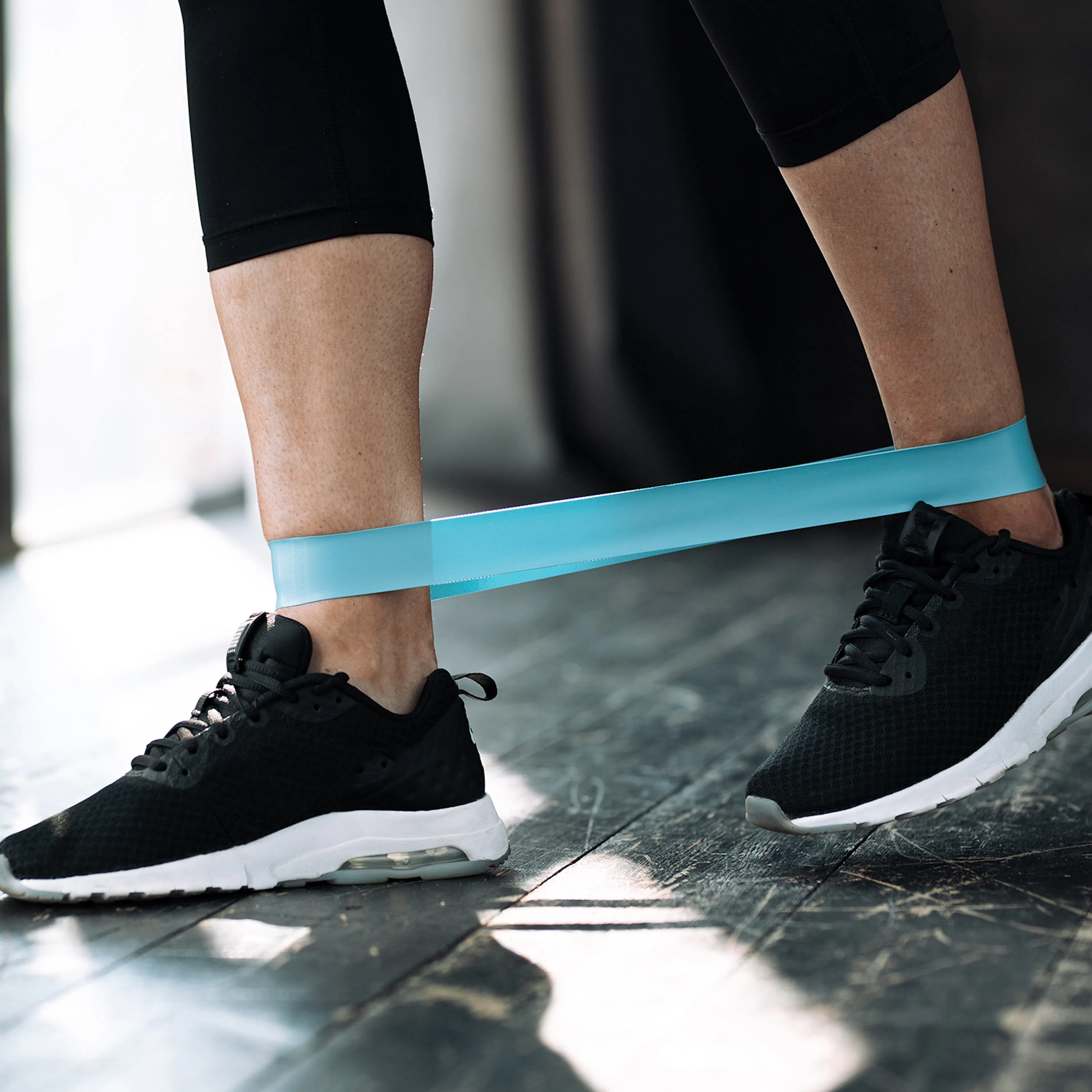 Female lower legs using a resistance band