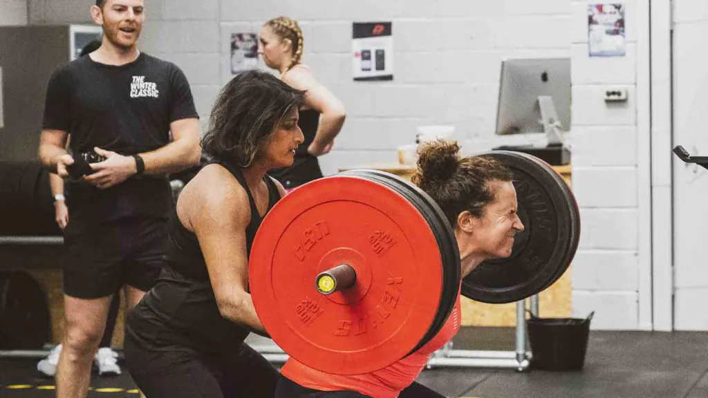 Ajanta Hilton assisting with powerlifting training