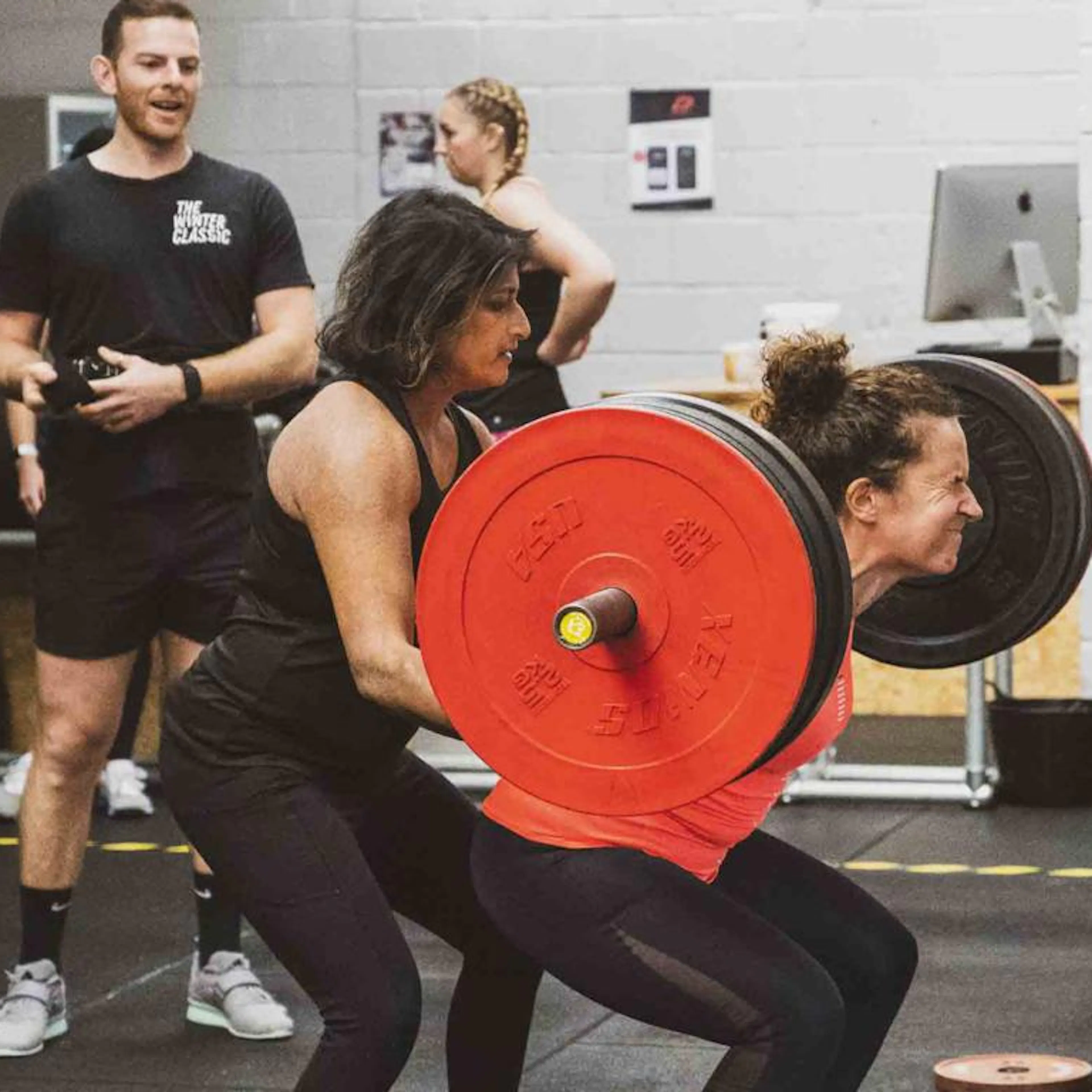 Ajanta Hilton assisting with powerlifting training 