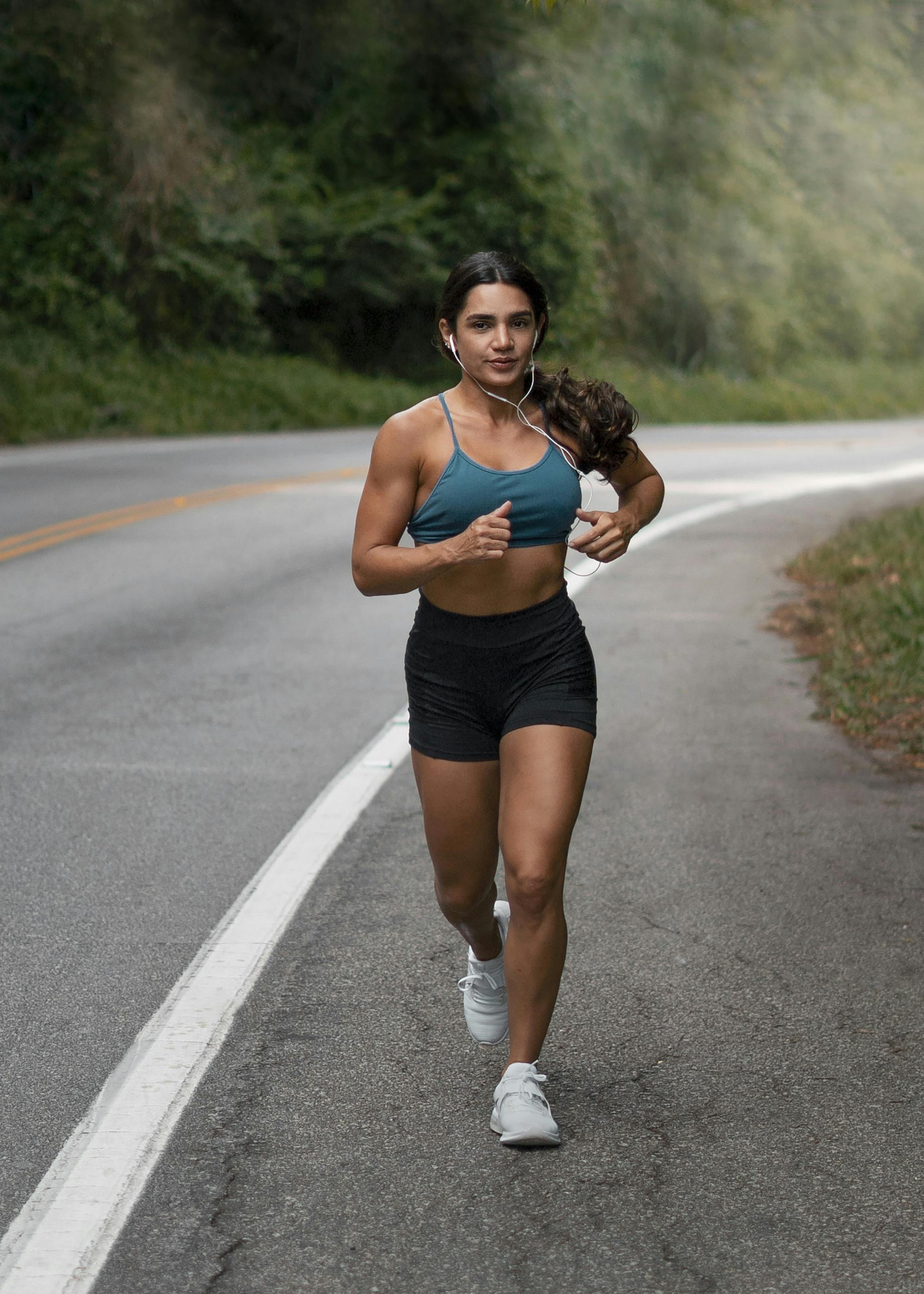 Fit woman running on the road.