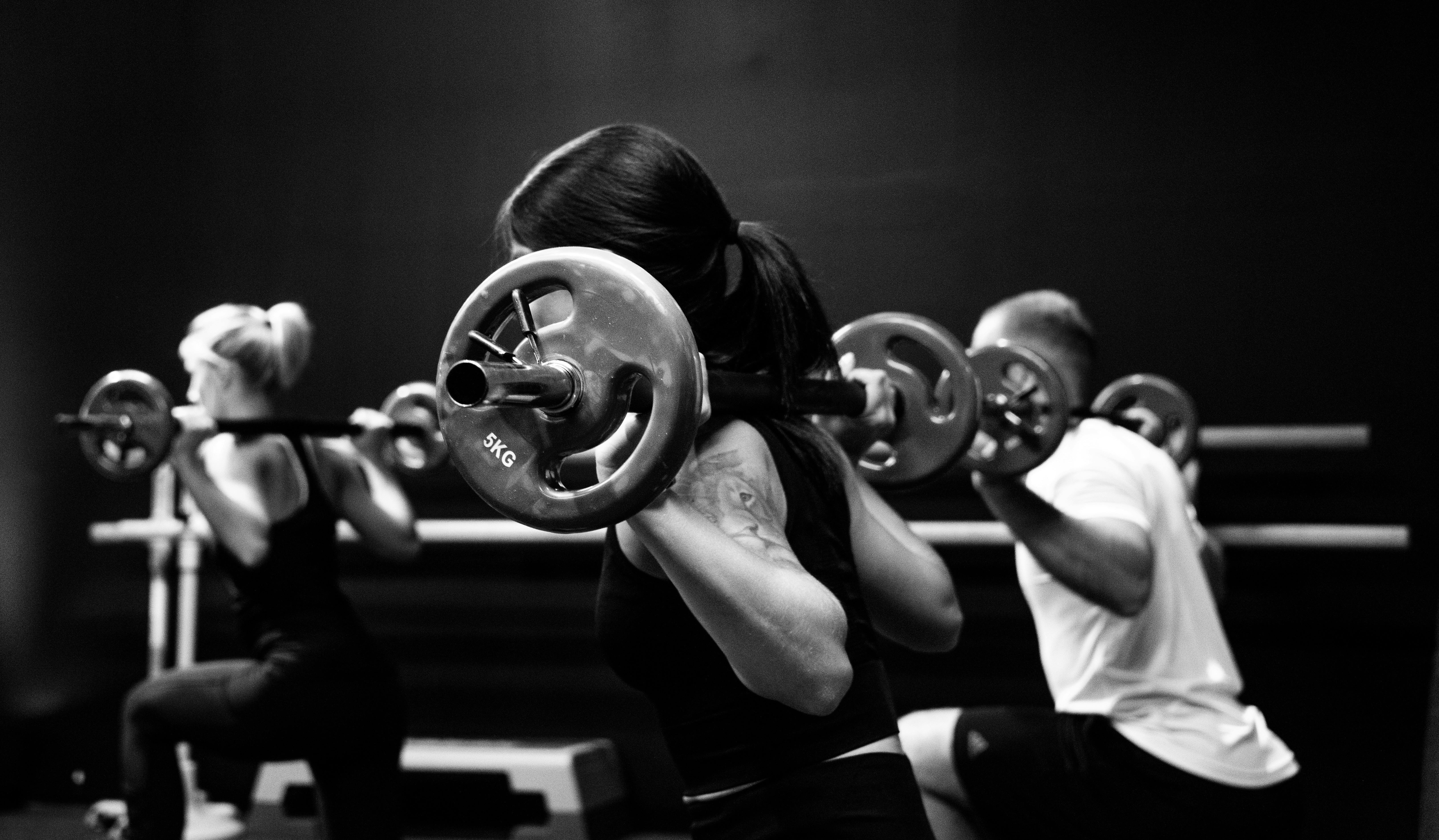 A woman doing a barbell squat
