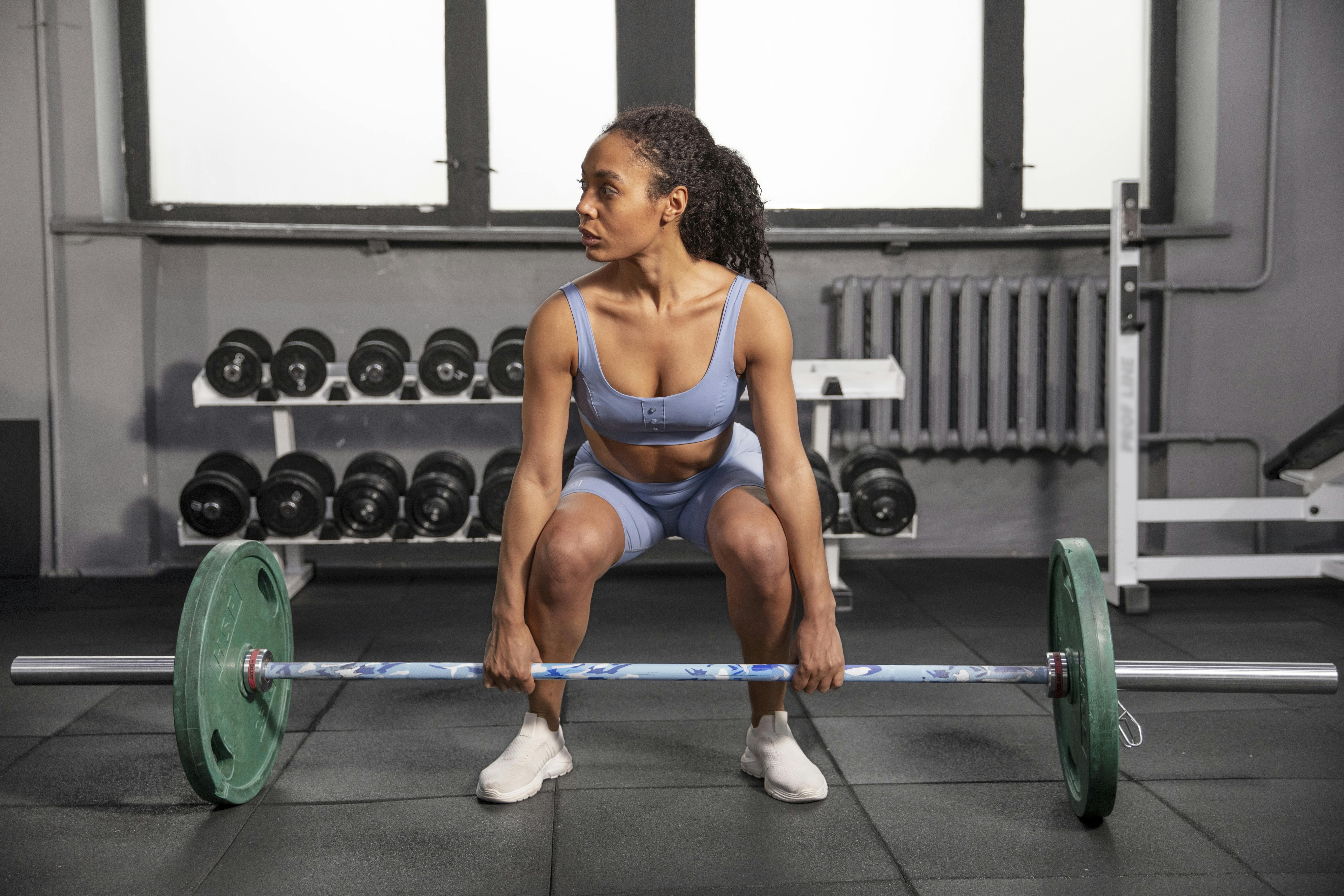 A woman is deadlifting.