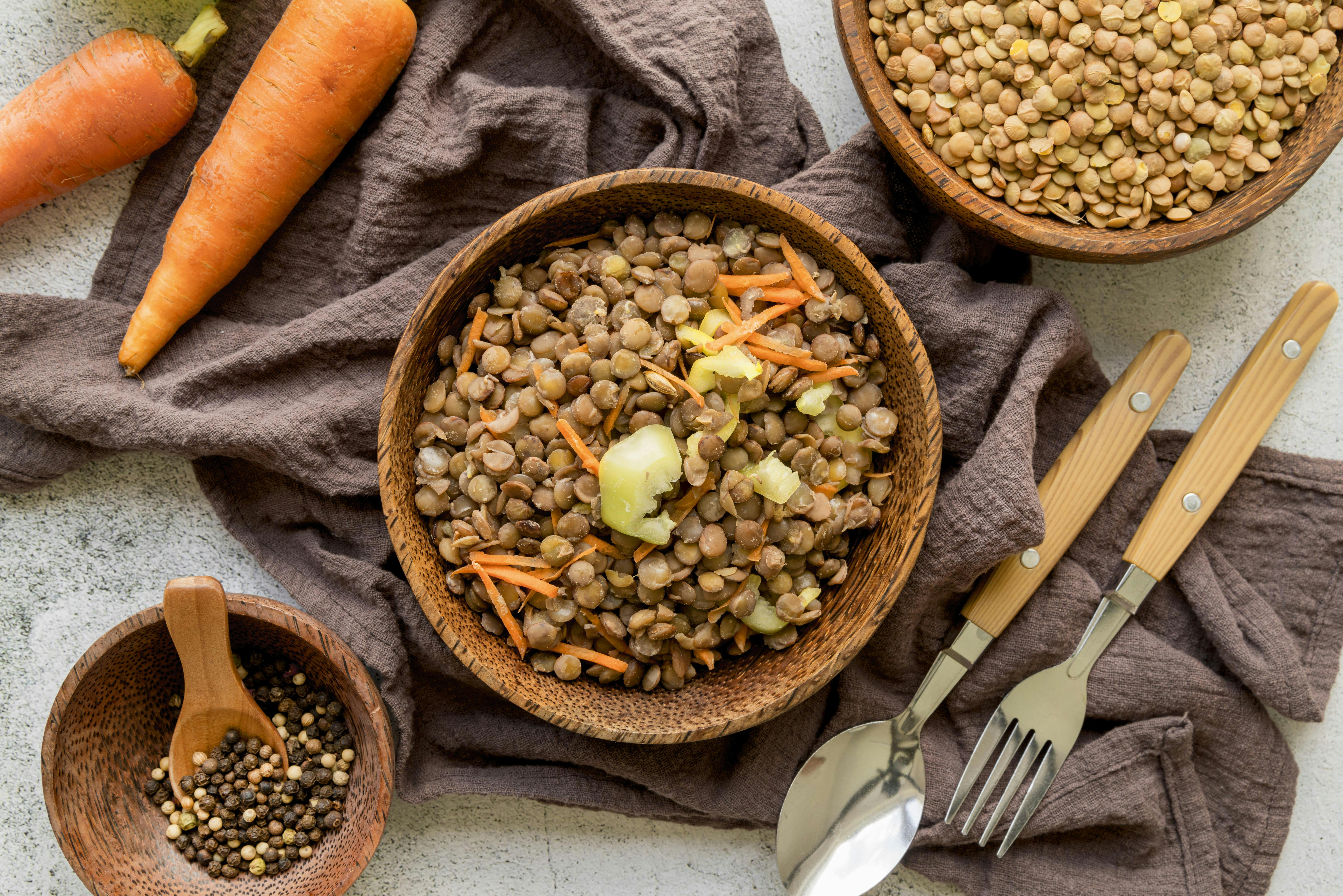 Picture of bowl of lentils with a carrot on the side.