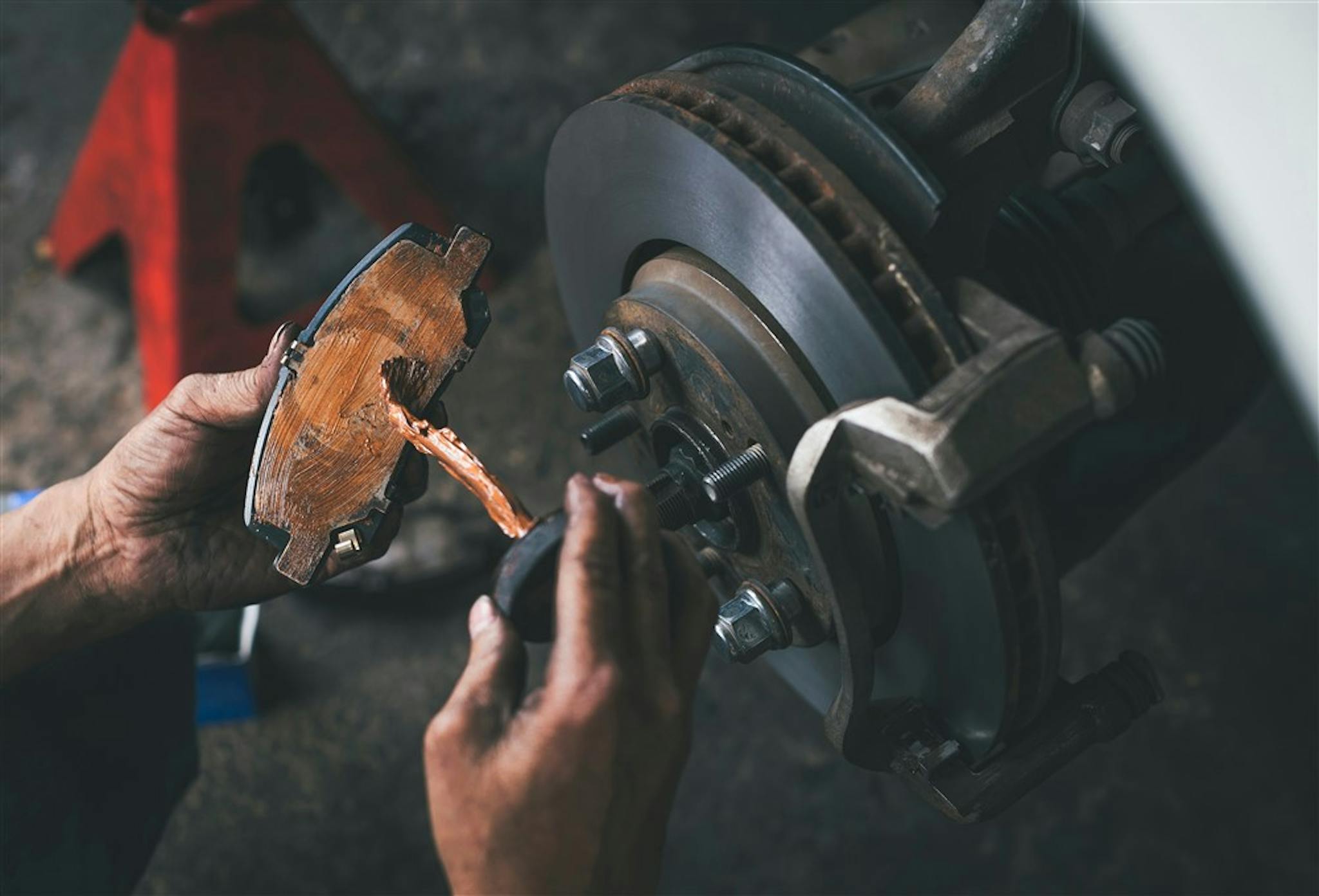 Applying lubricant to brake pad to eliminate brake noise