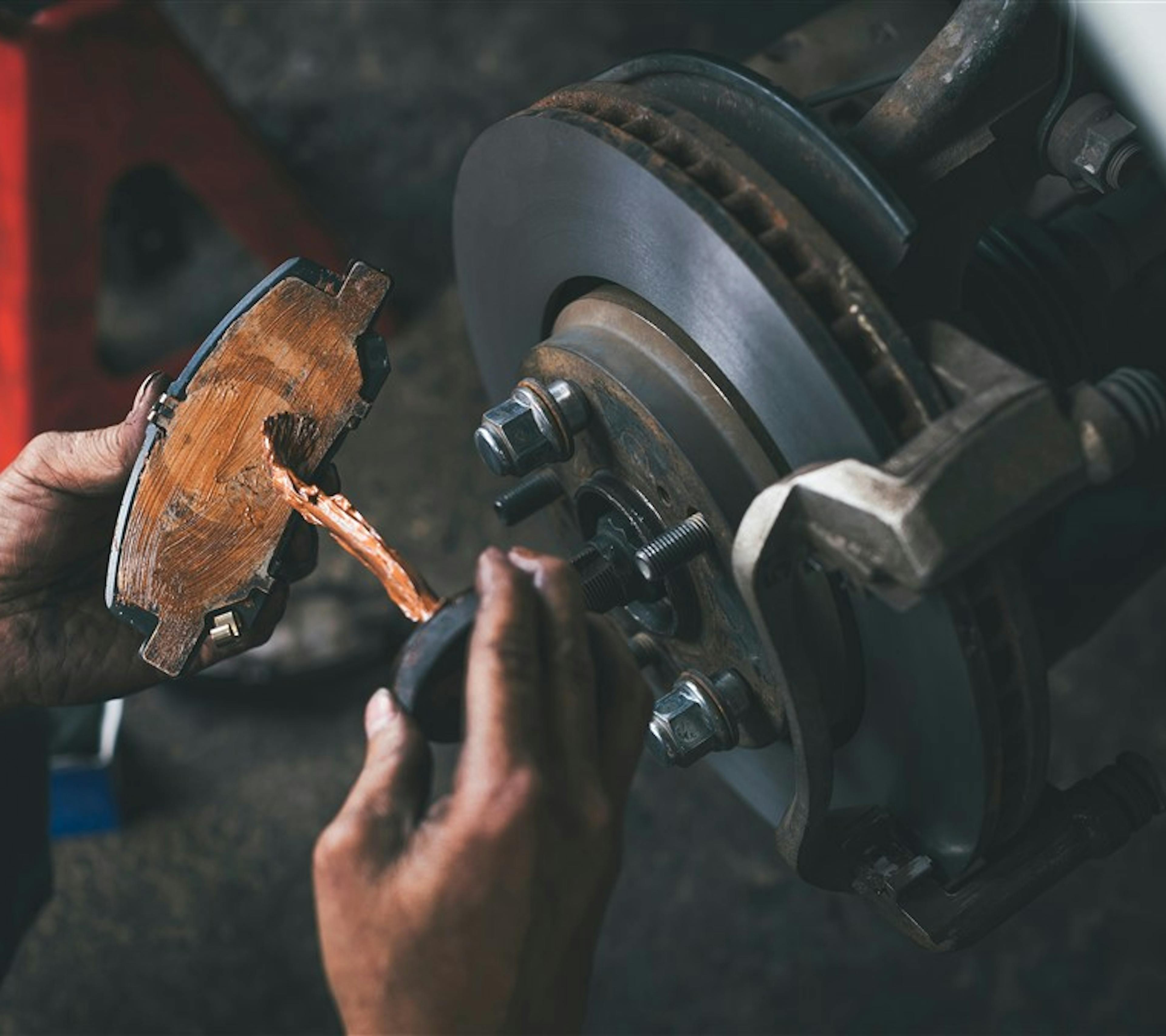 Applying lubricant to brake pad to eliminate brake noise