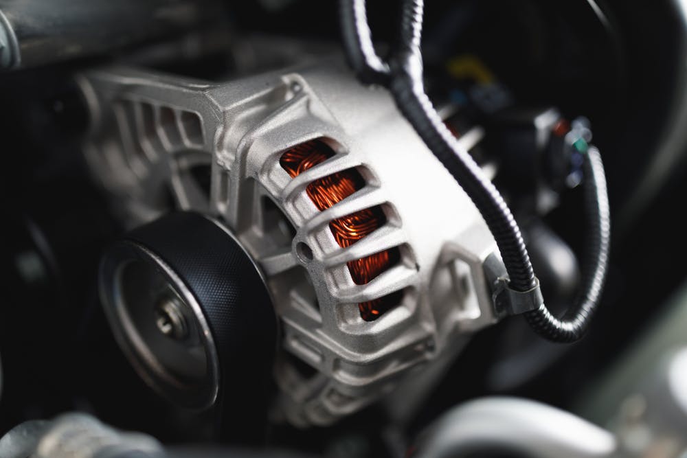 A car alternator fitted to an engine