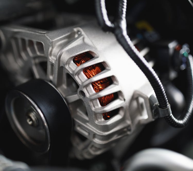 A car alternator fitted to an engine