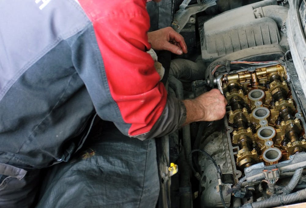 A mechanic replacing a rocker cover gasket