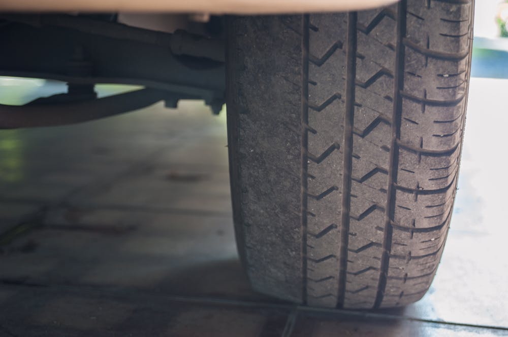 A worn car tyre caused by excessive negative camber wheel alignment