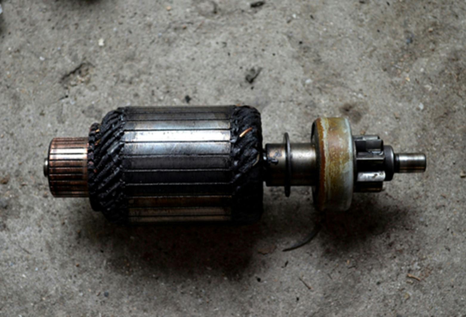 The armature found inside a starter motor laying on the ground