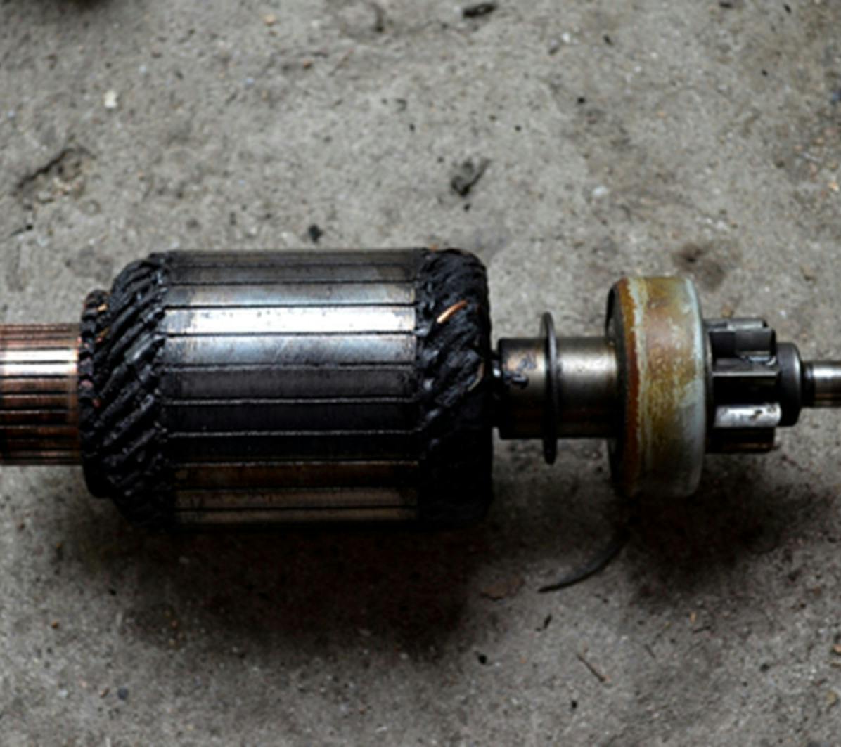 The armature found inside a starter motor laying on the ground