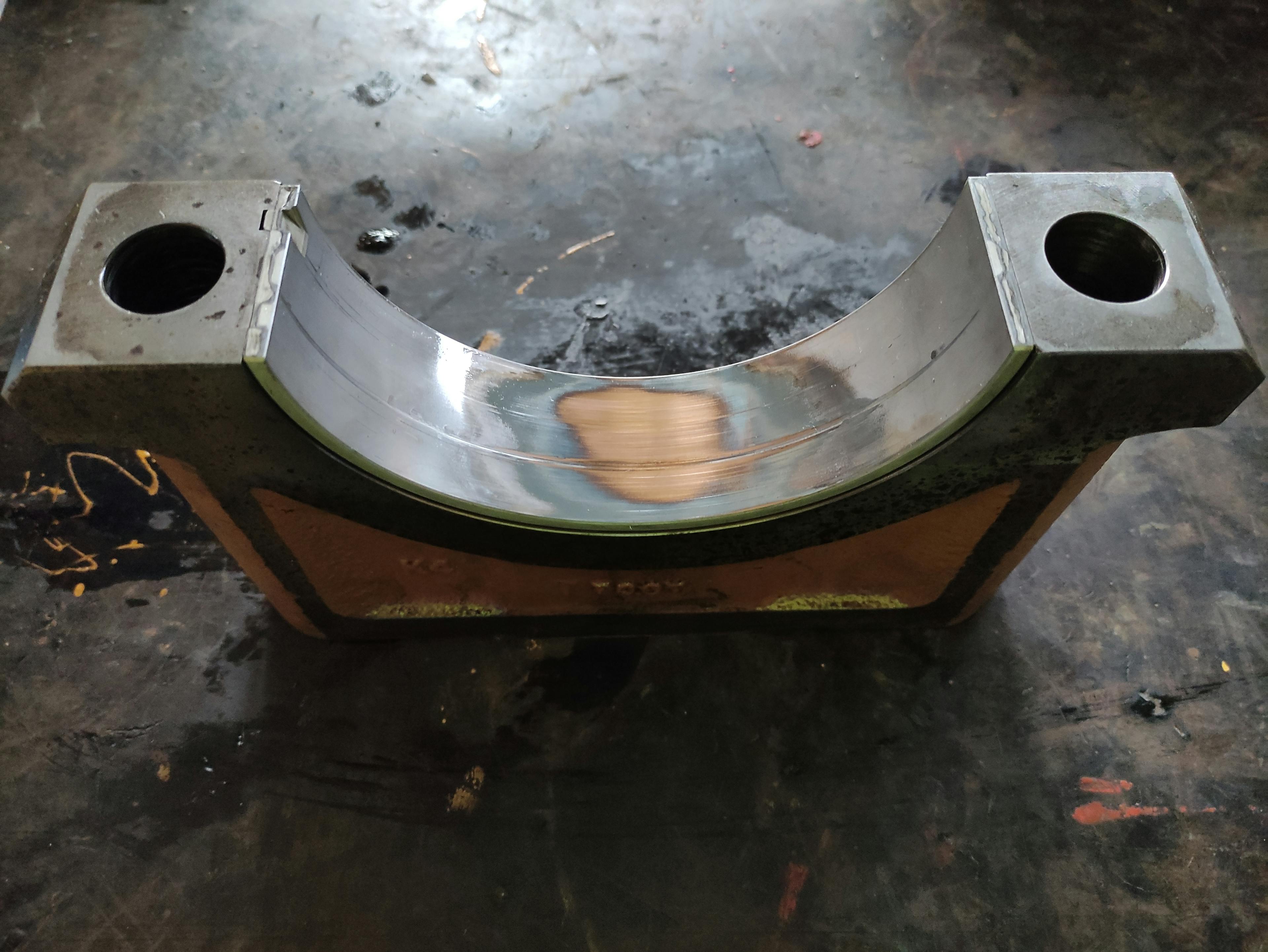 An engine bearing cap with a failed bearing