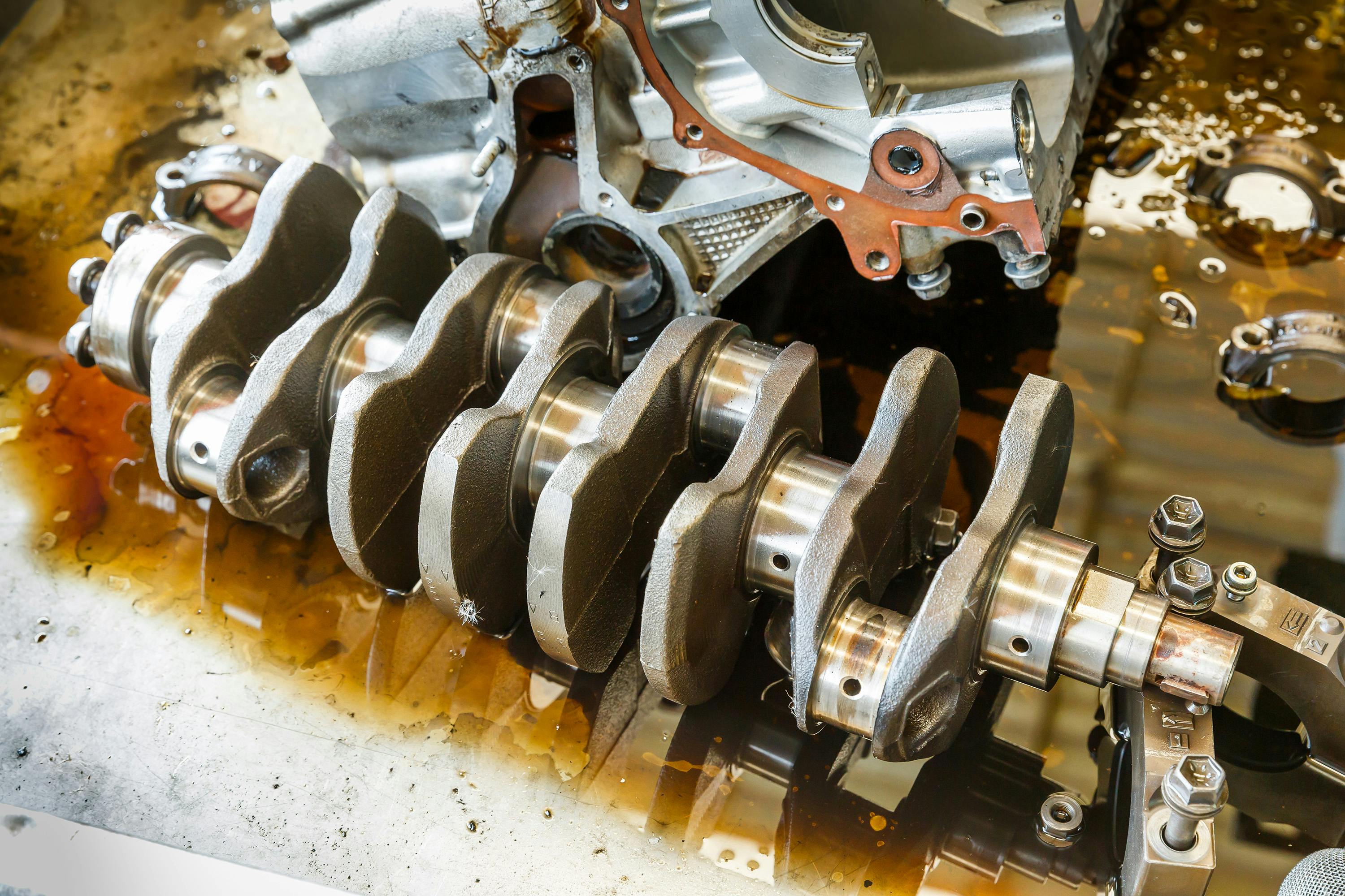 An engine crankshaft on a workbench