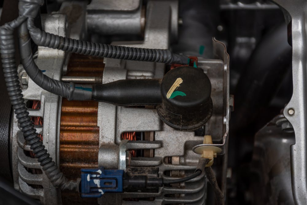 A smart car alternator fitted to an engine