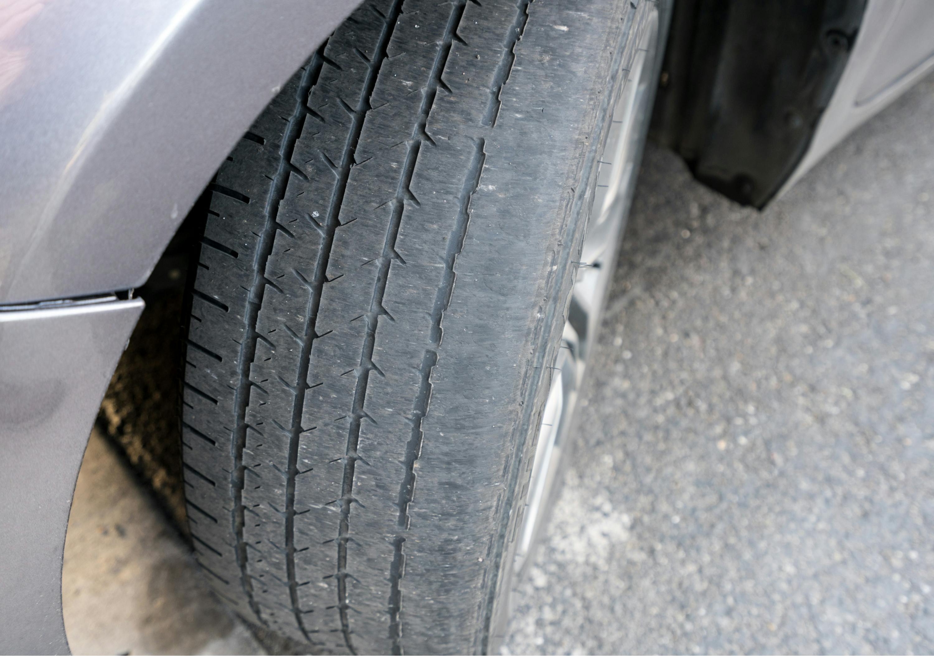 A worn car tyre caused by excessive wheel alignment toe-in