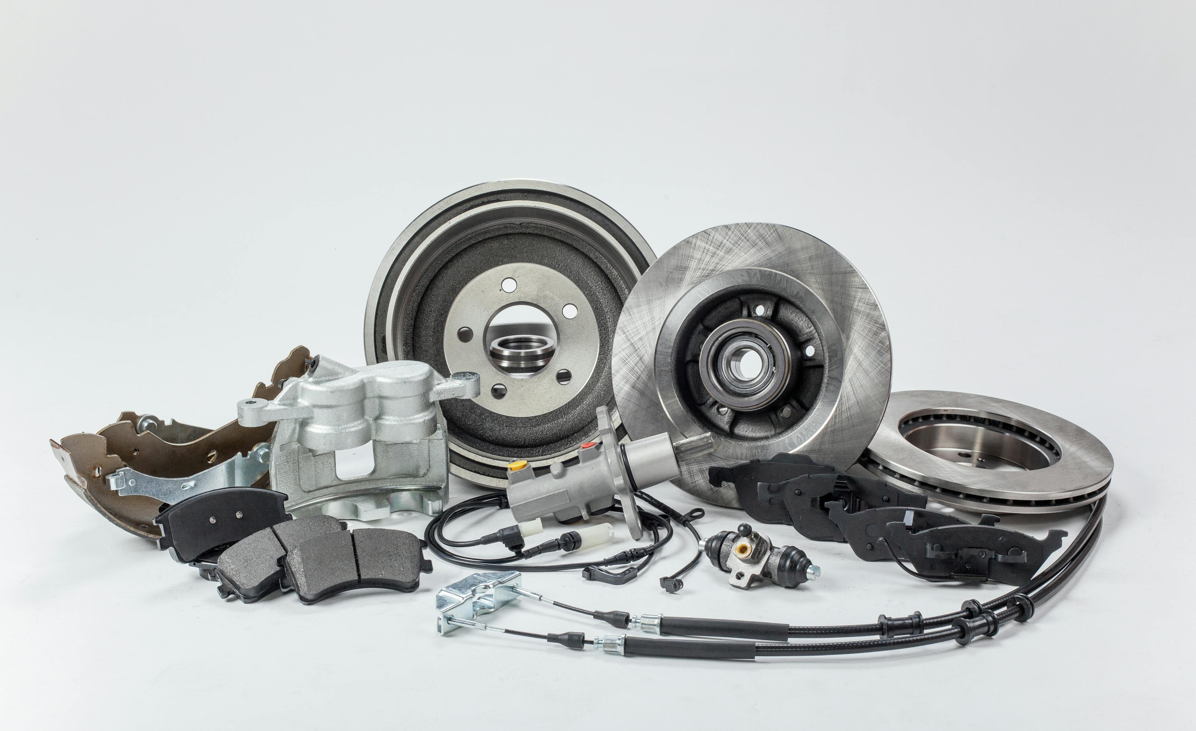 an assortment of car parts against a grey background