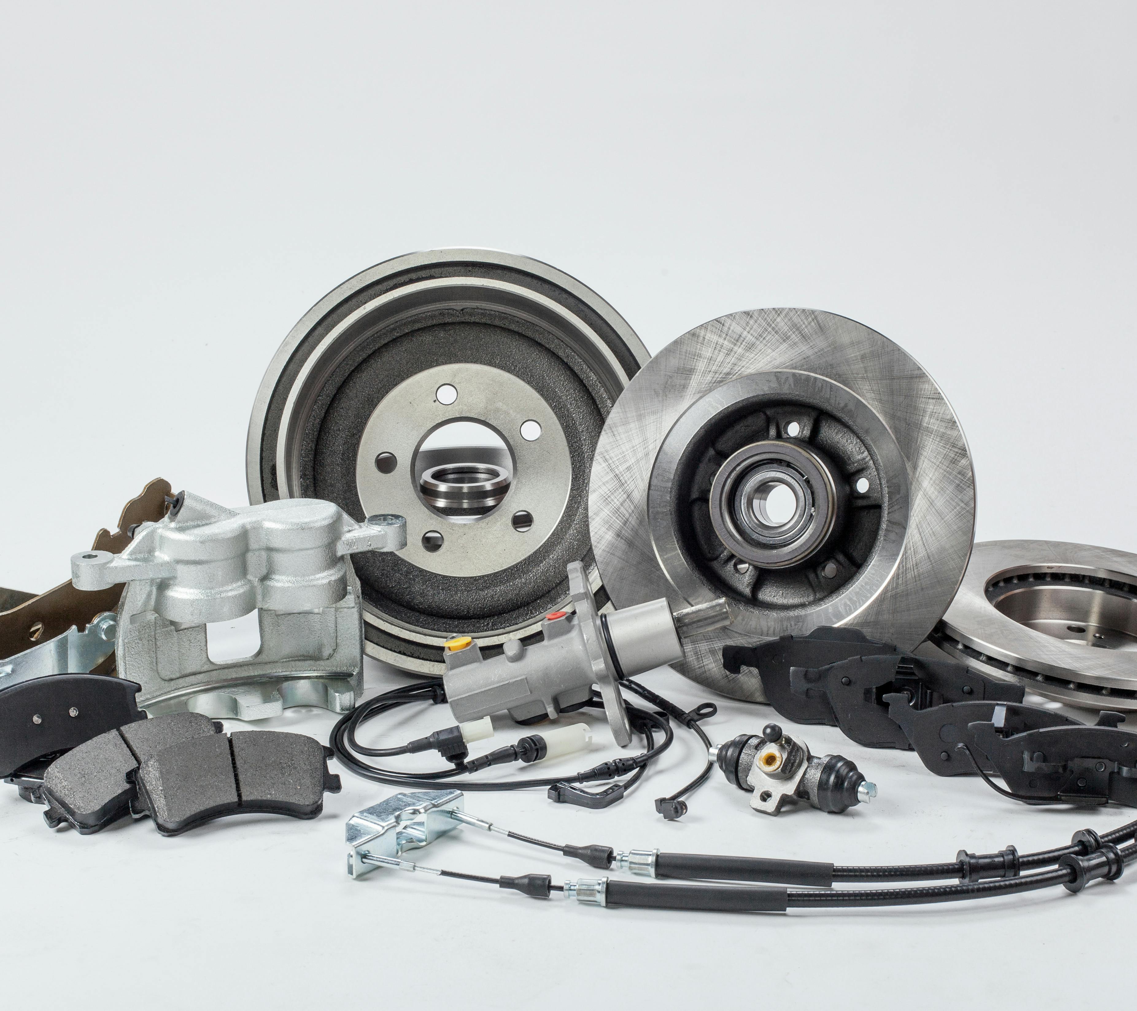 an assortment of car parts against a grey background