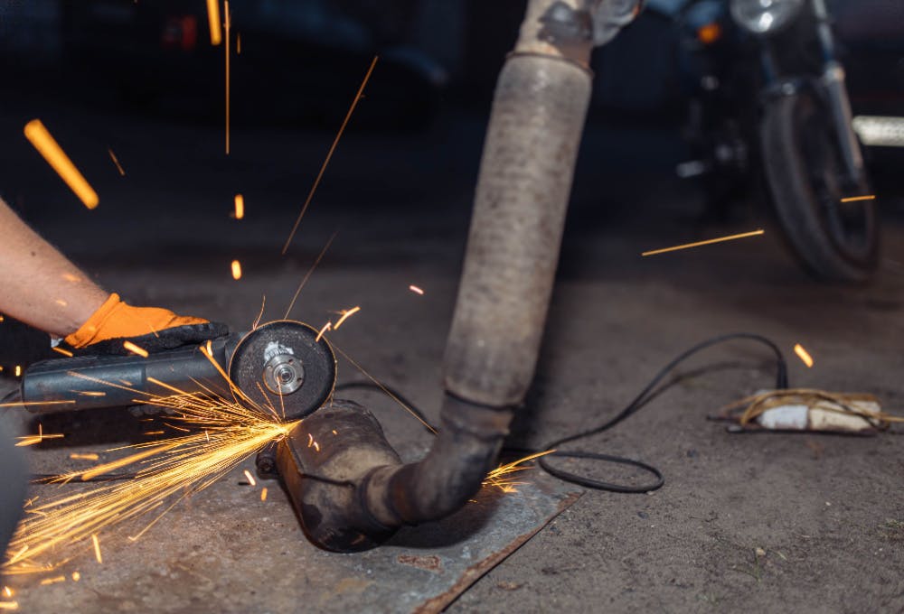 A mechanic part being worked on with a saw.