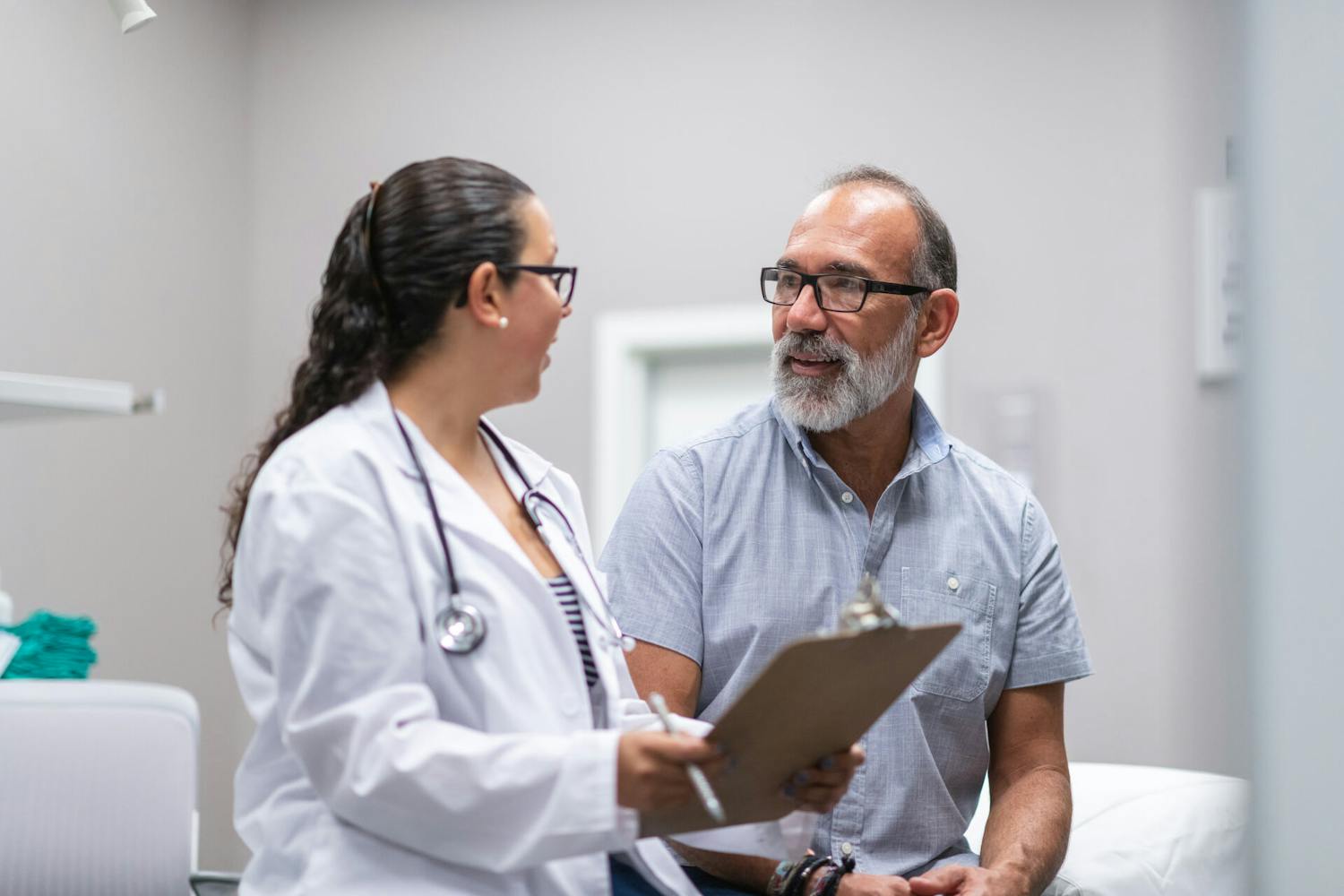 A doctor providing results of cardiovascular testing to a male patient 