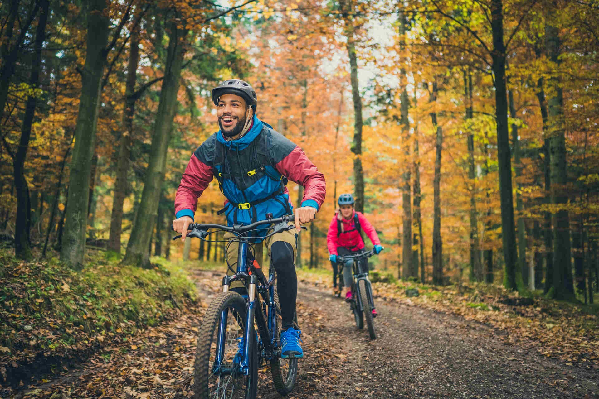 Couple biking through forest