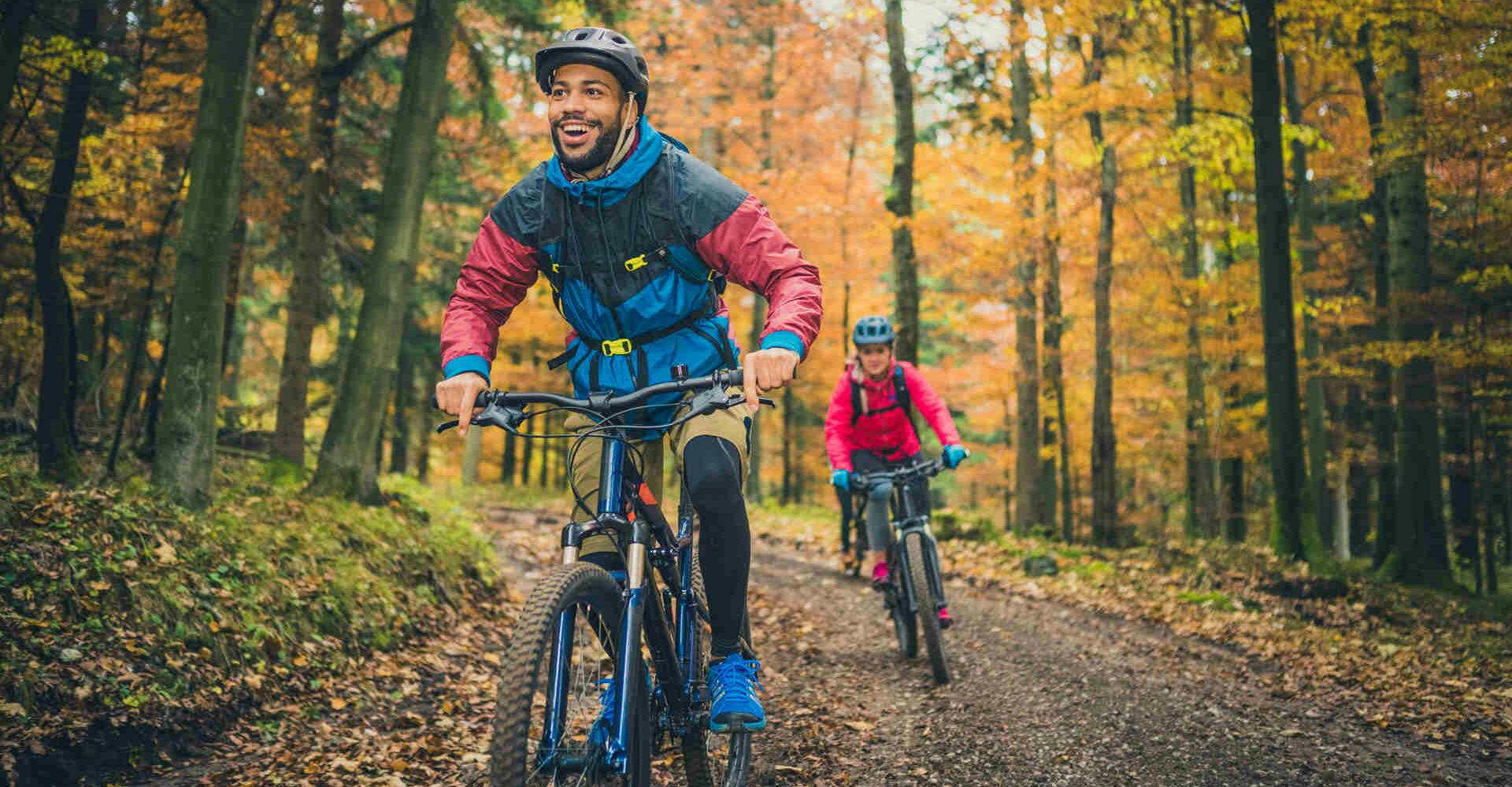 Couple biking through forest