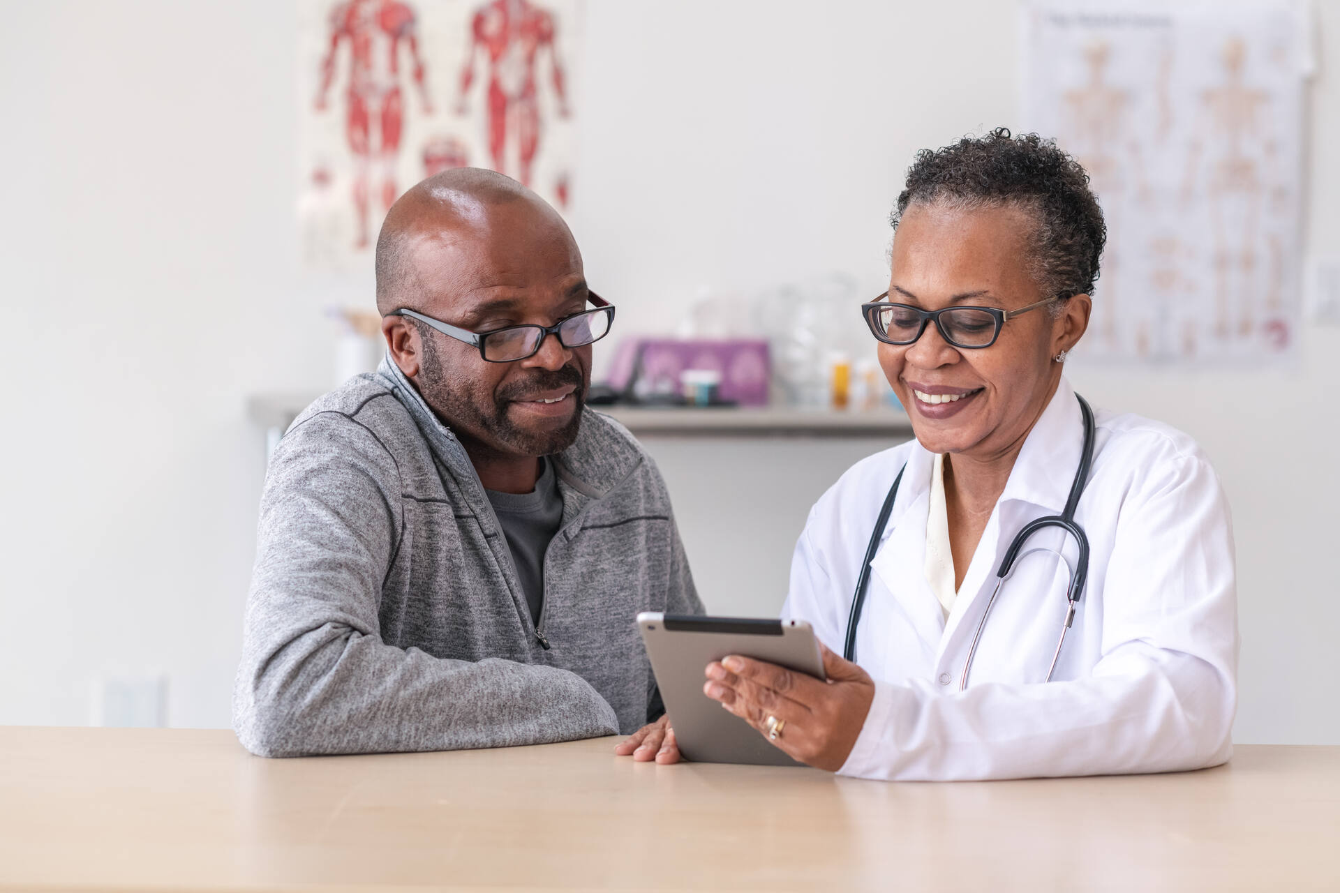 Doctor sitting beside patient