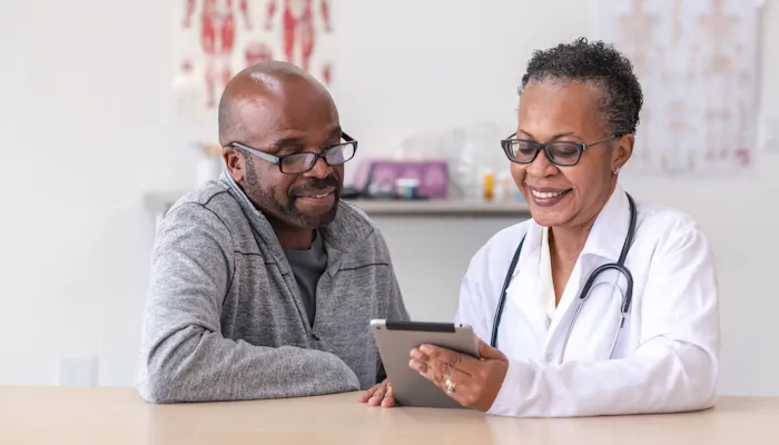 Doctor sitting beside patient
