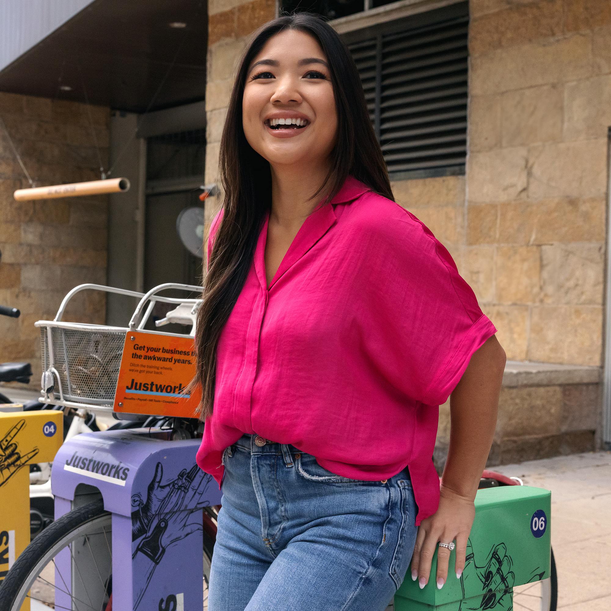 Nurse in normal clothes leaning on bike rack